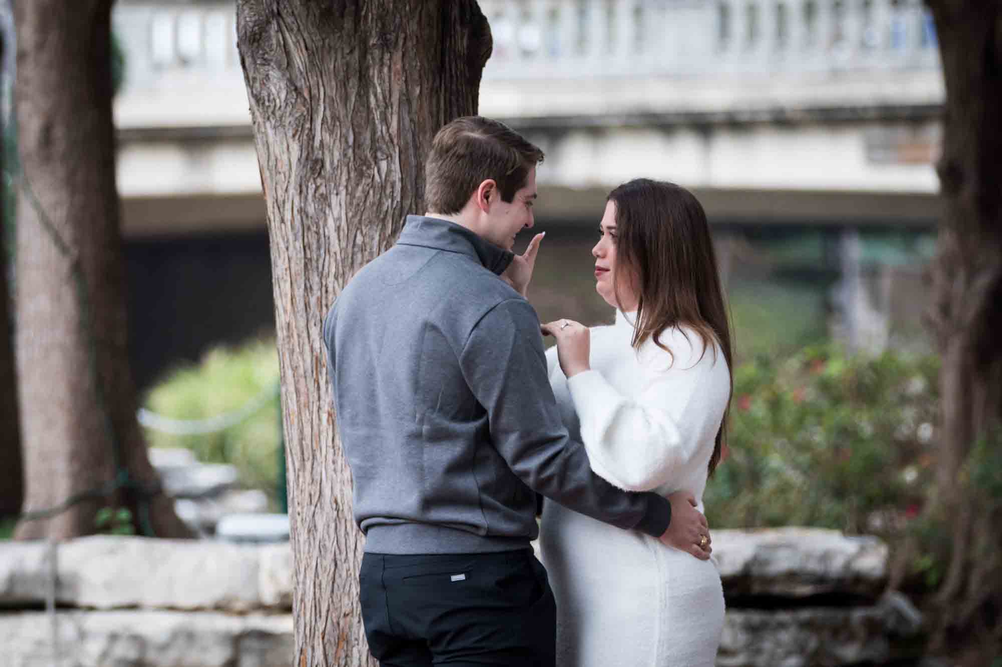 Couple hugging on little island during a surprise proposal at the Pearl