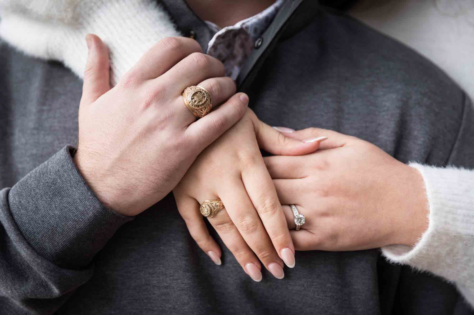 Close up of couple's hands showing engagement ring