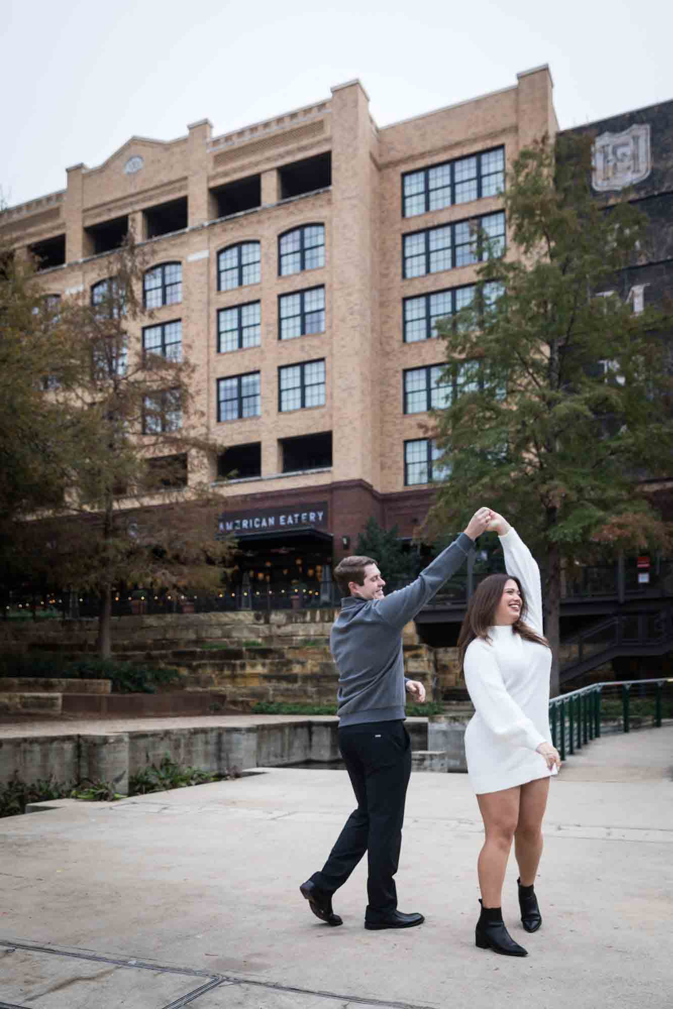 Couple dancing in front of Hotel Emma for an article on rain backup photo locations at the Pearl in San Antonio