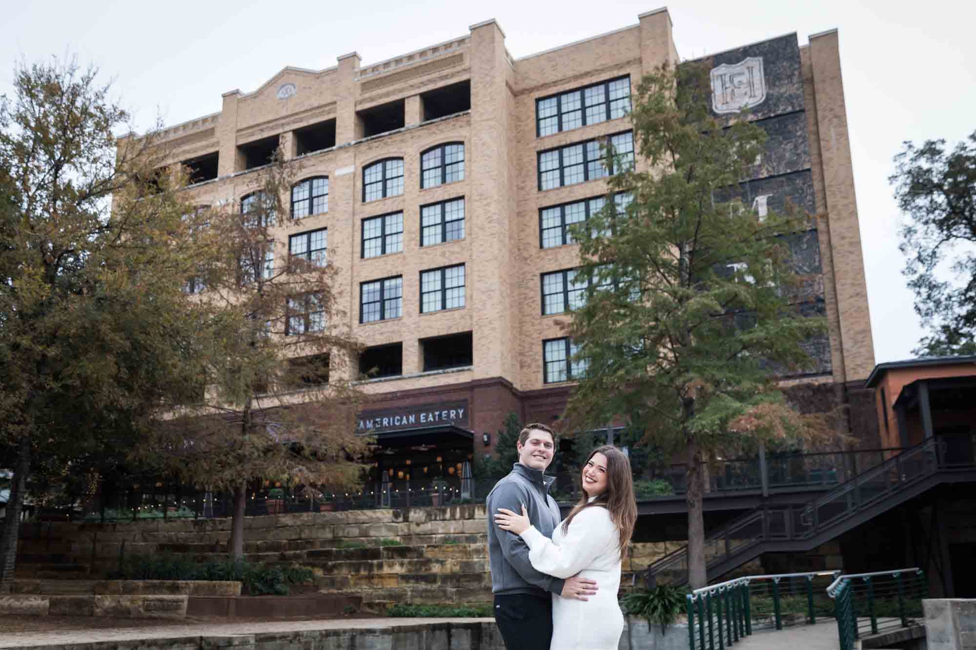 Couple dancing in front of Hotel Emma for an article on rain backup photo locations at the Pearl in San Antonio