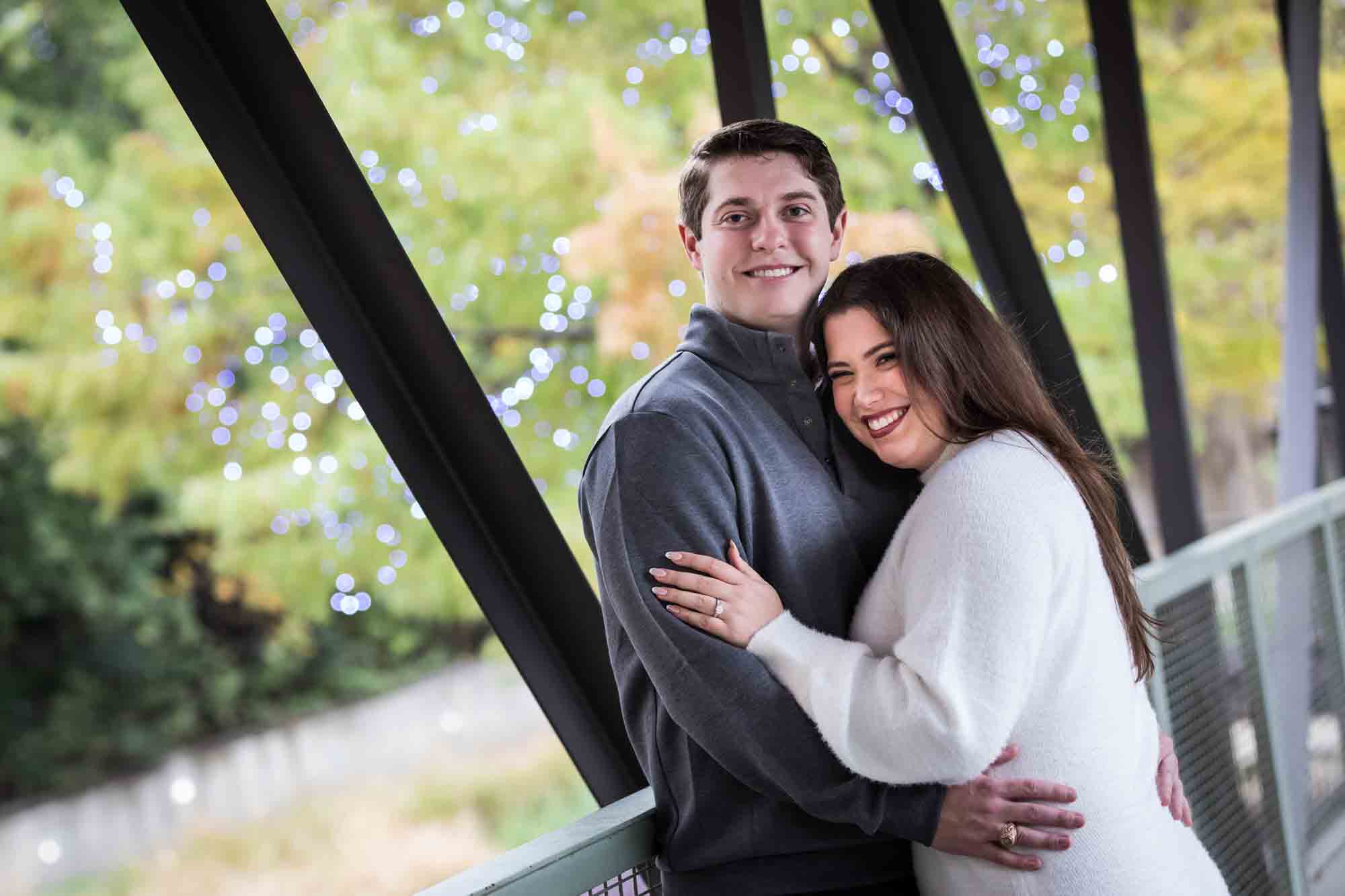 Couple hugging on main bridge for an article on rain backup photo locations at the Pearl in San Antonio