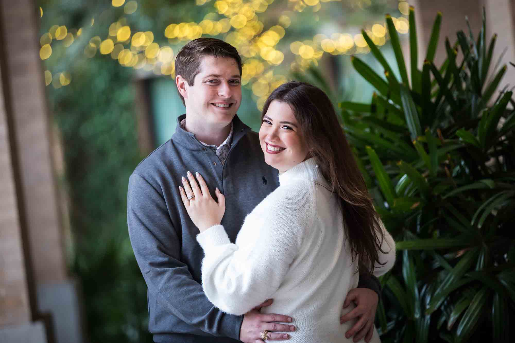 Couple hugging in Cellar vaulted entryway during an engagement photo shoot at the Pearl