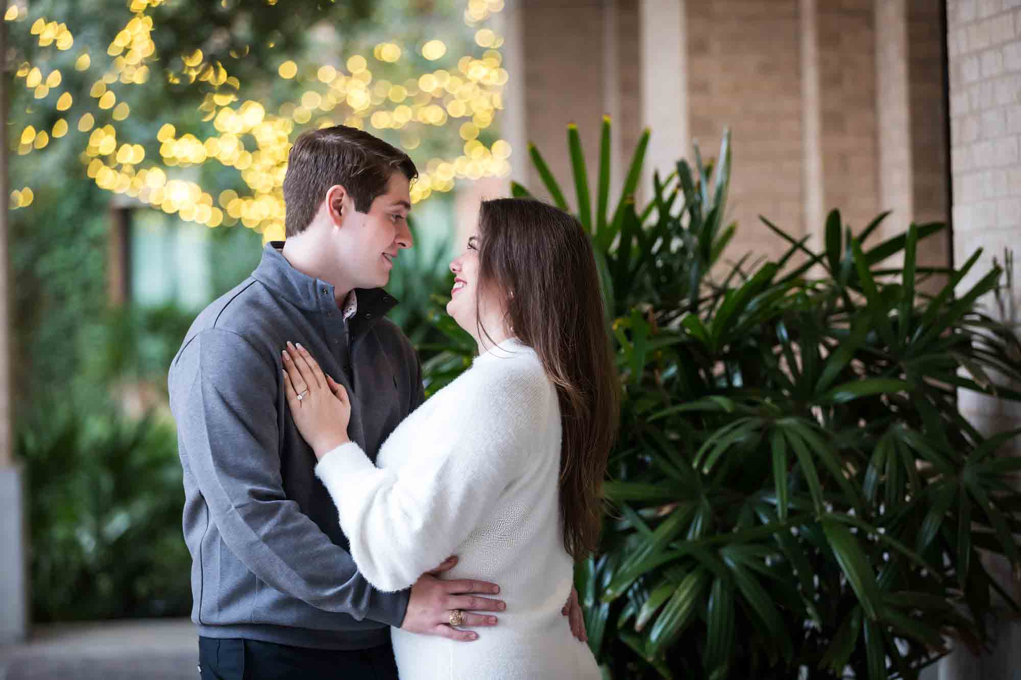 Couple hugging in Cellar vaulted entryway during an engagement photo shoot at the Pearl