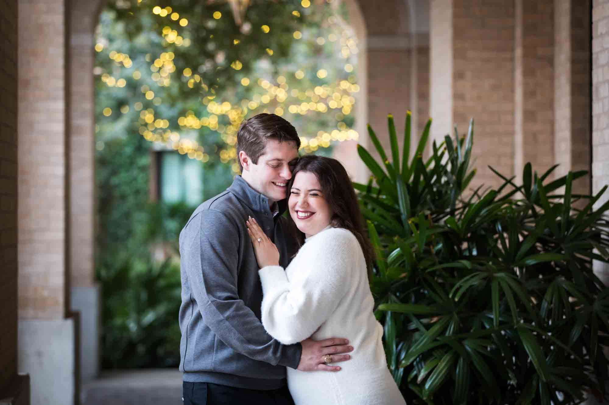 Couple hugging in Cellar vaulted entryway during an engagement photo shoot at the Pearl