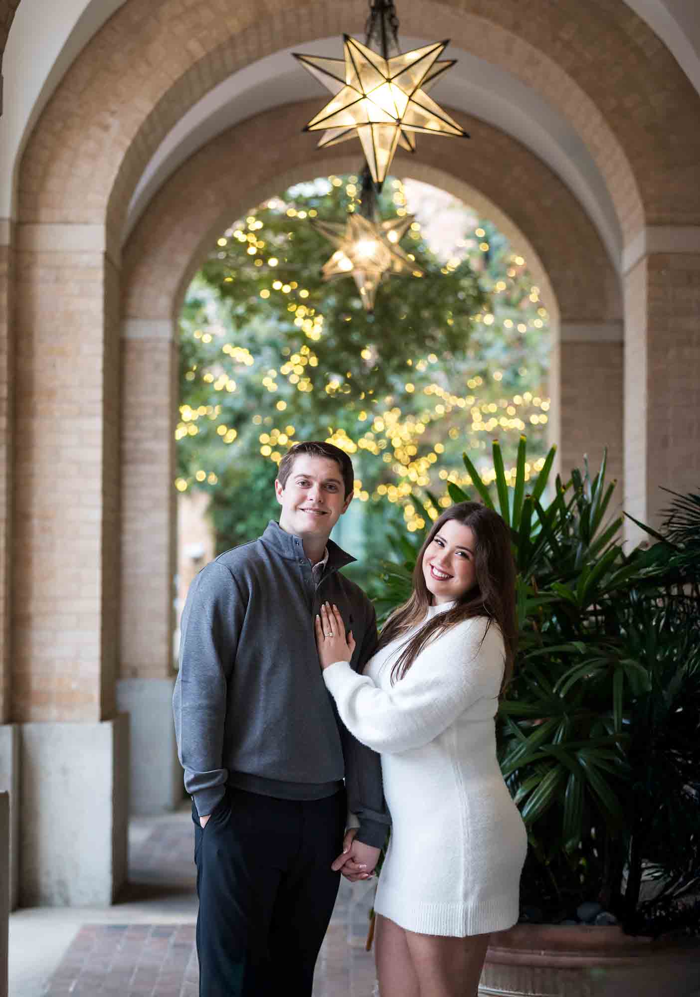 Couple hugging in Cellar vaulted entryway during an engagement photo shoot at the Pearl