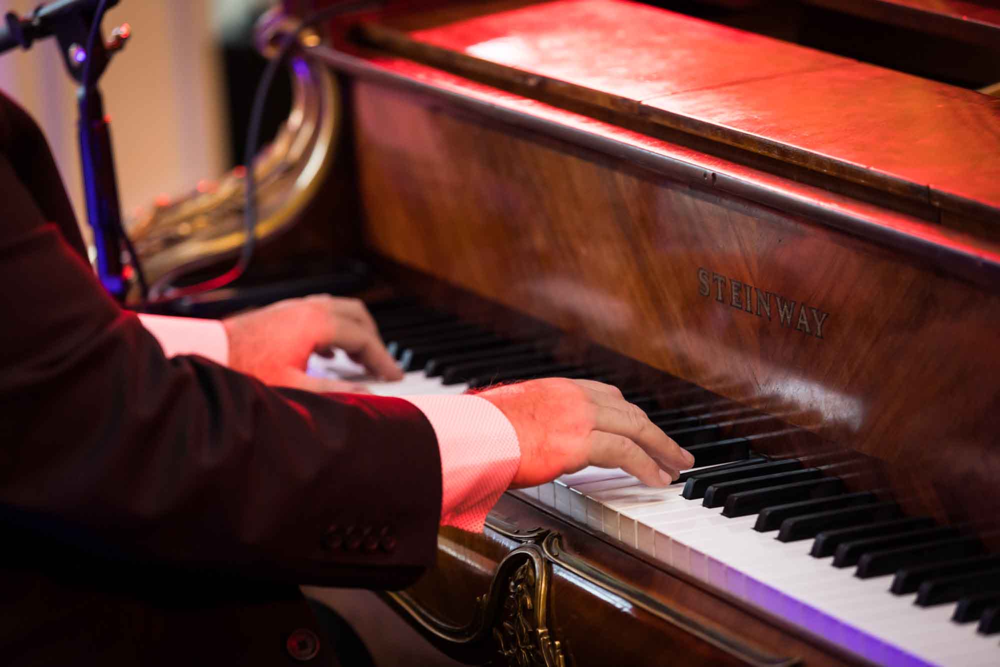 Close up of male piano player playing a vintage Steinway piano