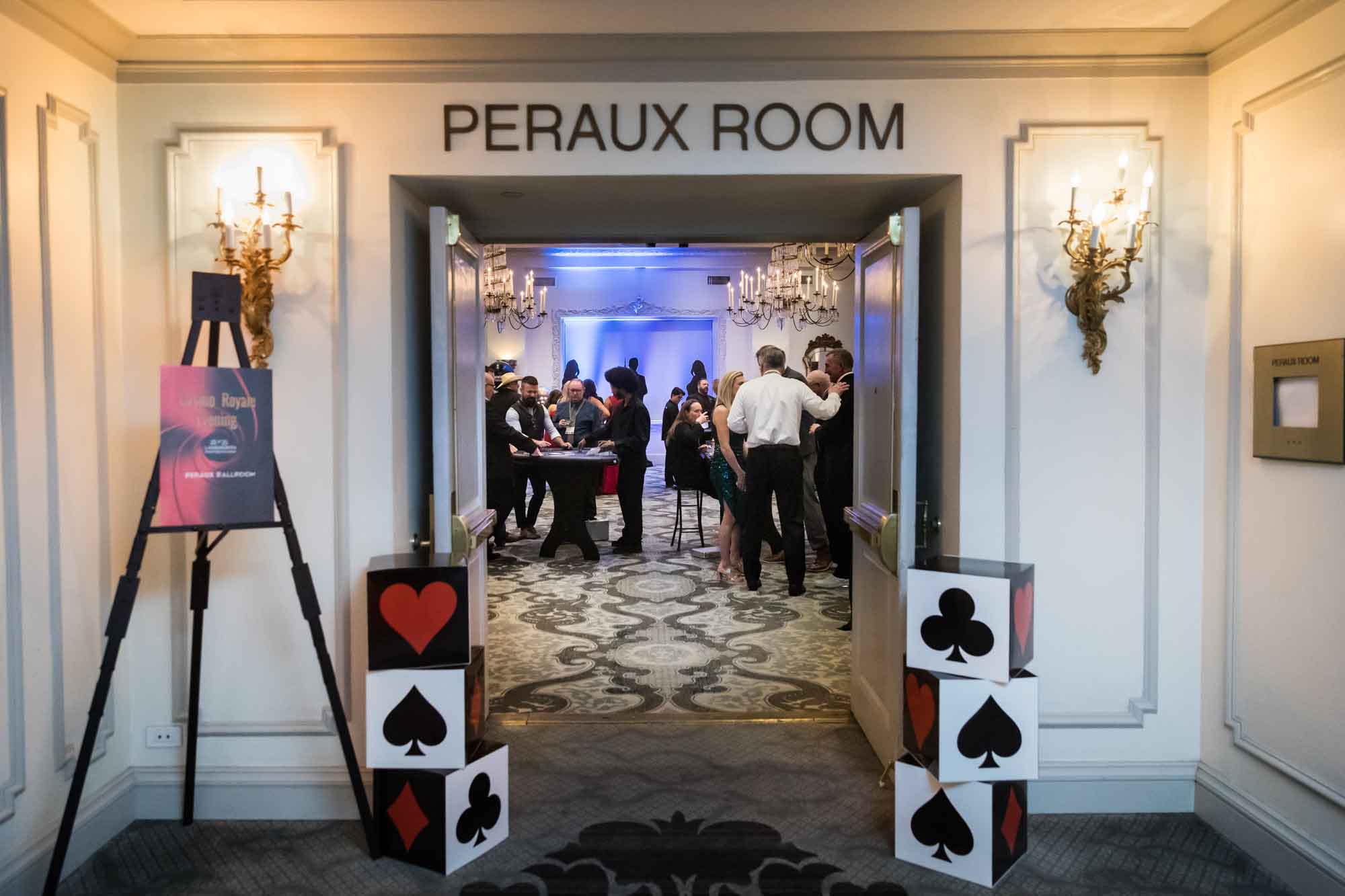 Entrance to Peraux Room with stacked cubes decorated with card suites for an article on a St. Anthony Hotel corporate event