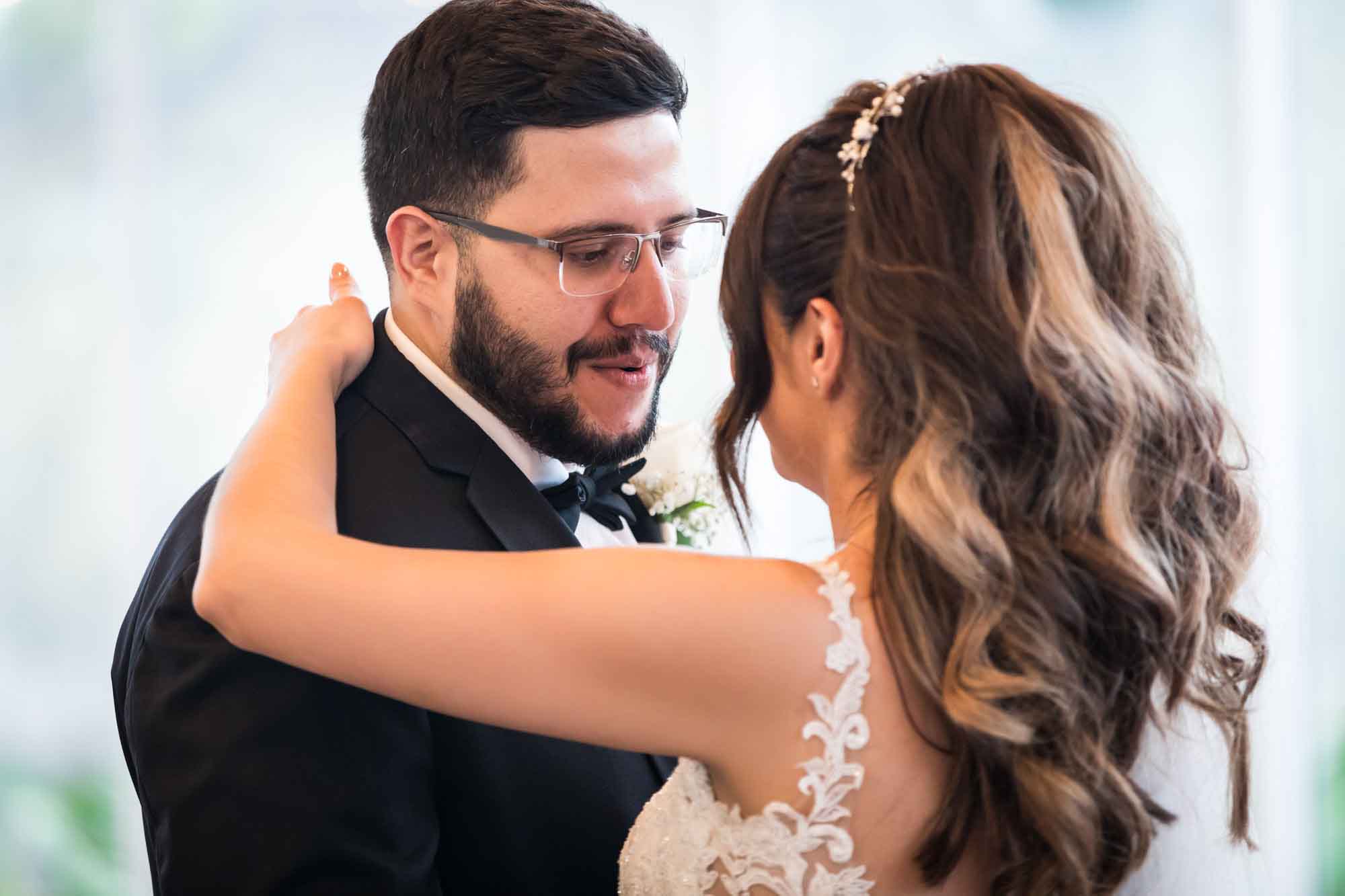 Bride and groom dancing with groom looking intently at bride for an article on top 20 things to ask your wedding photographer