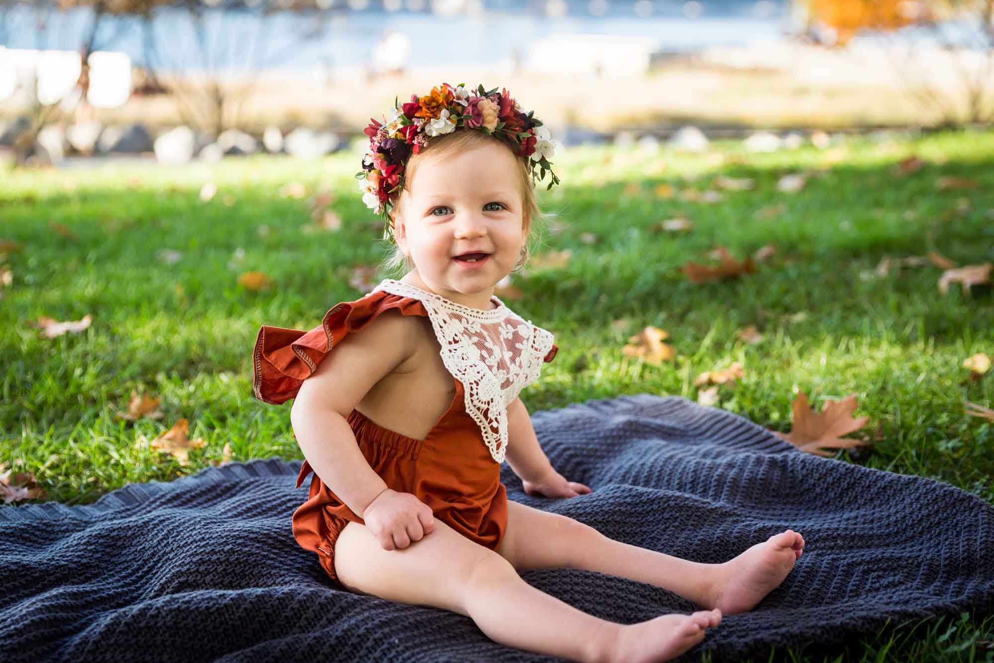 Little girl sitting on a blanket for an article NYC golden hour portrait tips