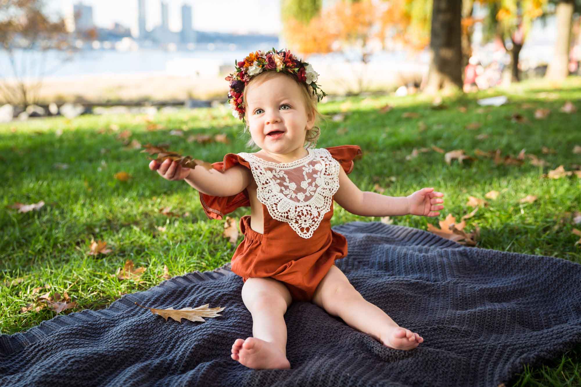 Little girl holding out leaf for an article NYC golden hour portrait tips