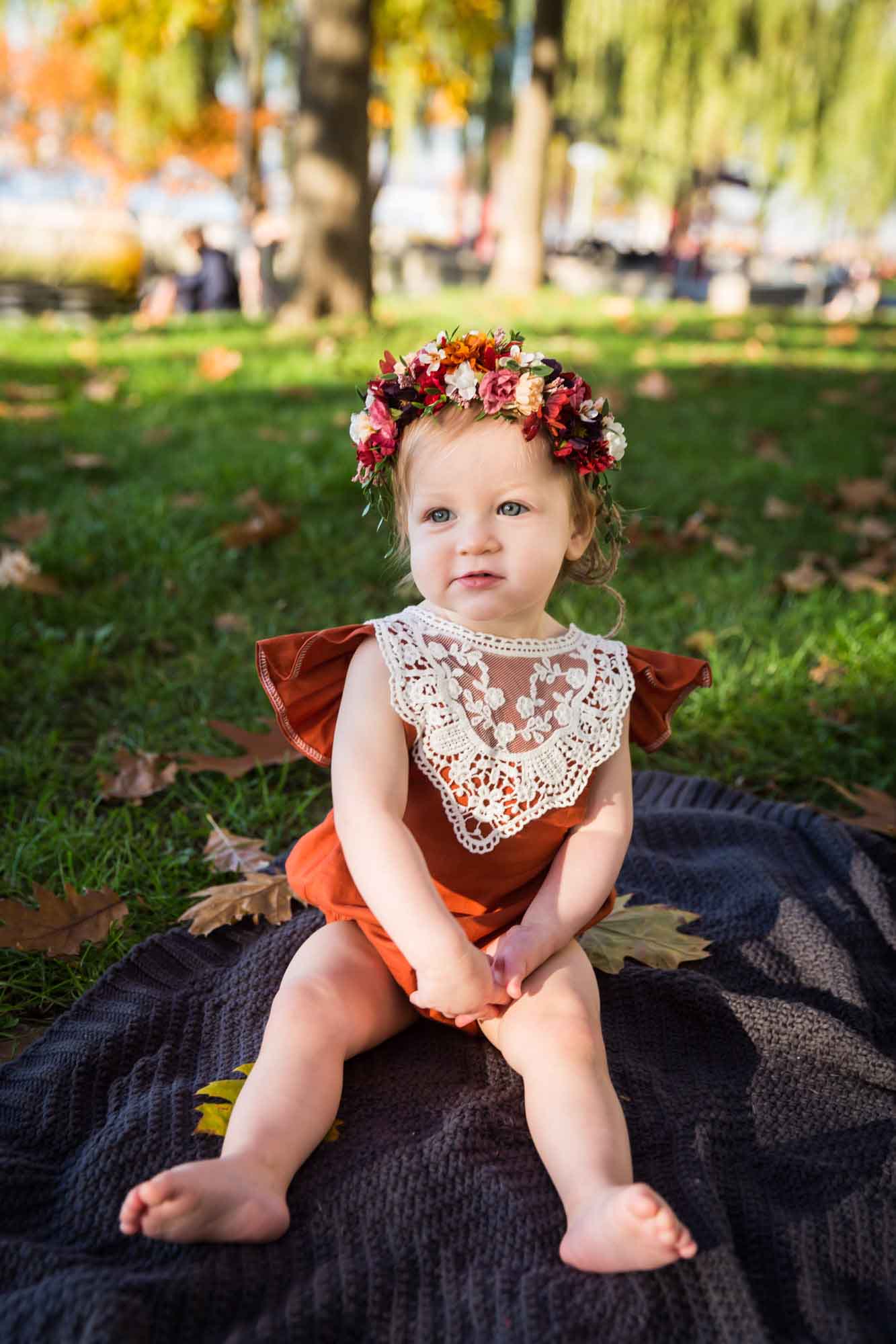 Little girl sitting on a blanket for an article NYC golden hour portrait tips