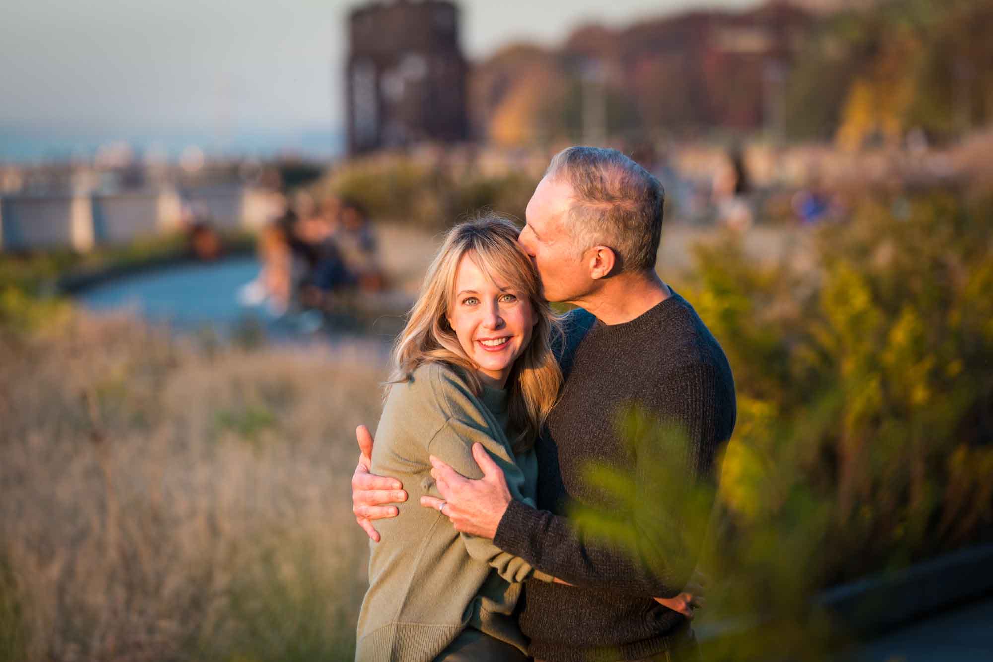 Man kissing woman on the side of the head for an article NYC golden hour portrait tips