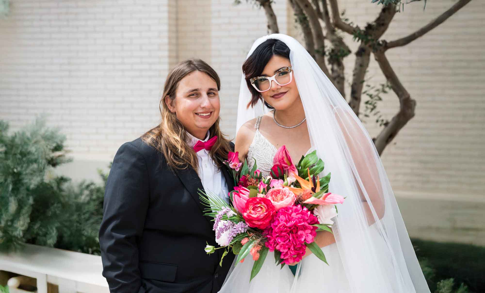 Cornerstone Church wedding photos of bride and groom standing close to each other in courtyard with tree in background