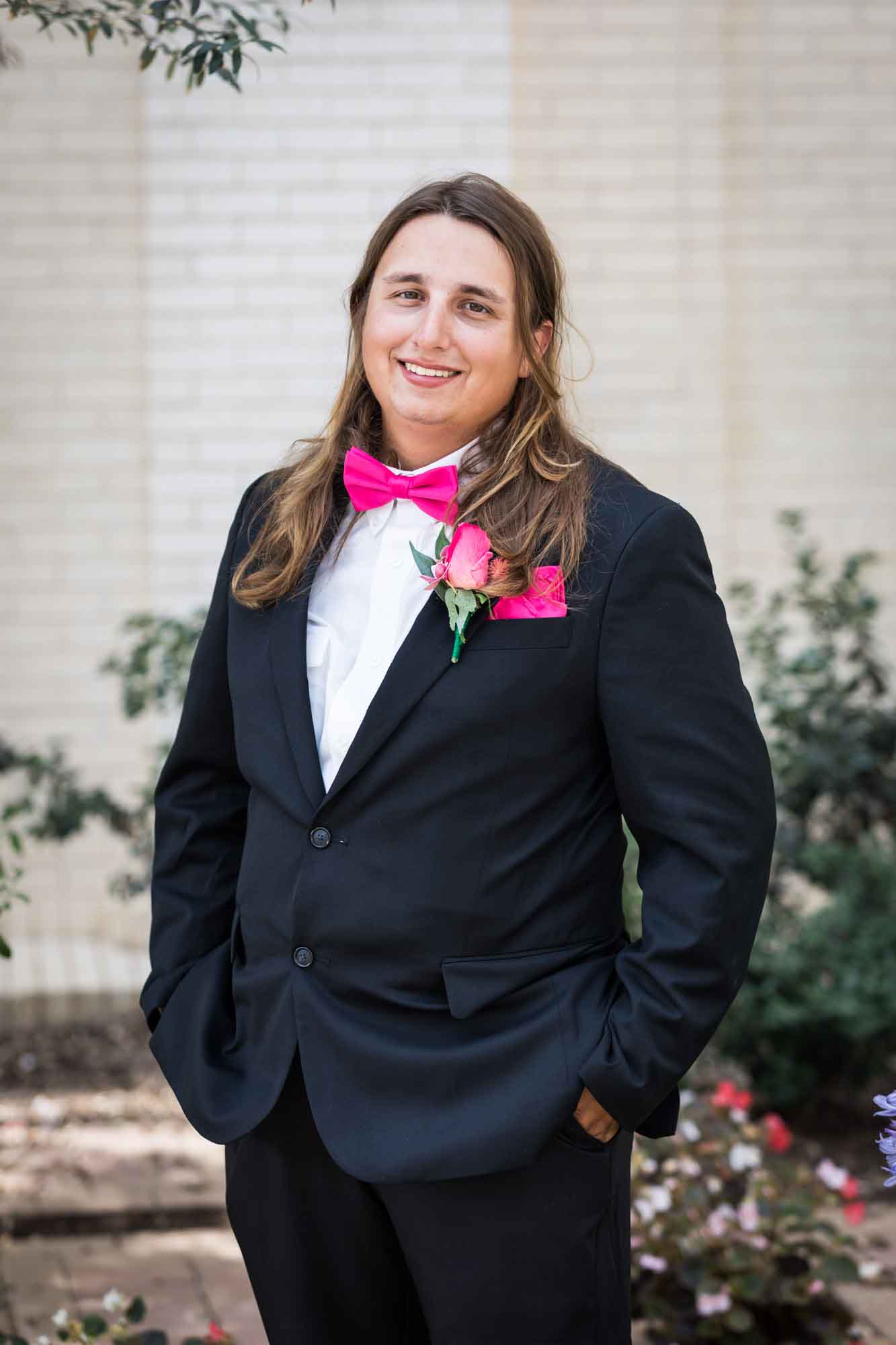 Cornerstone Church wedding photos of groom wearing black suit and pink bow tie