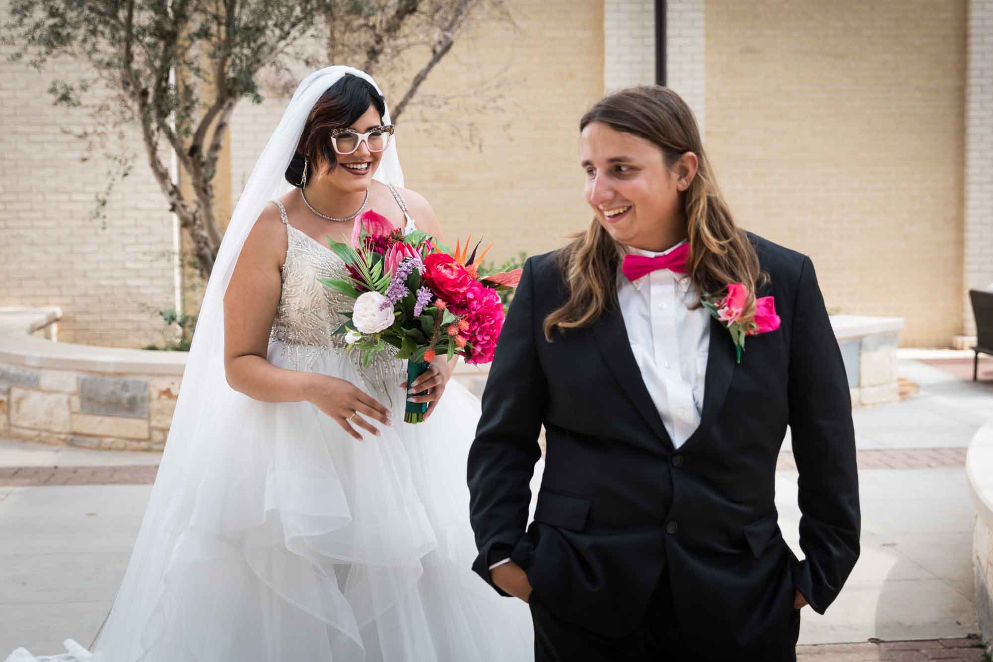 Cornerstone Church wedding photos of bride wearing veil and holding flower bouquet about to tap groom during first look