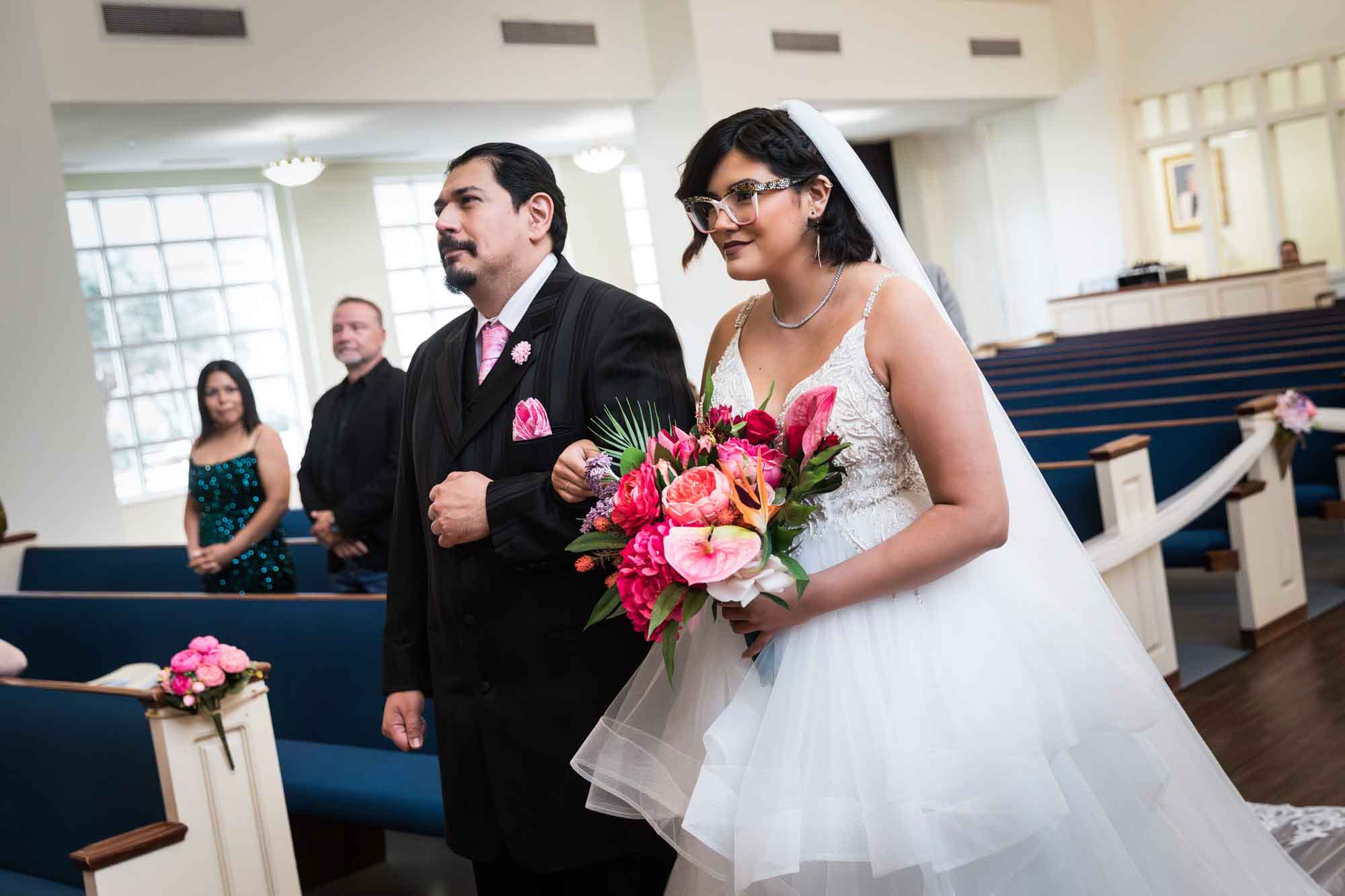 Cornerstone Church wedding photos of bride holding flower bouquet and father walking down aisle during ceremony