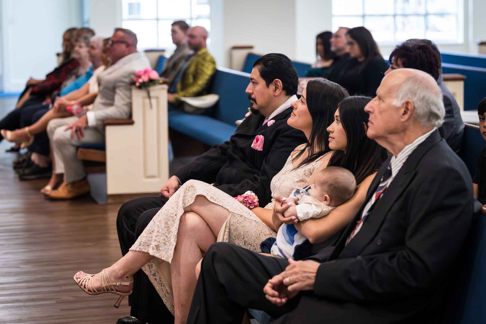 Cornerstone Church wedding photos of guests in pews watching ceremony