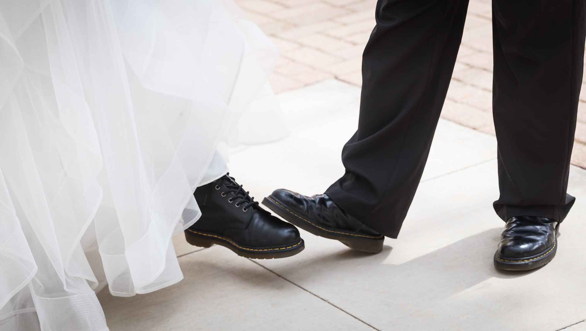 Close up view of bride and groom comparing Dr. Marten footwear