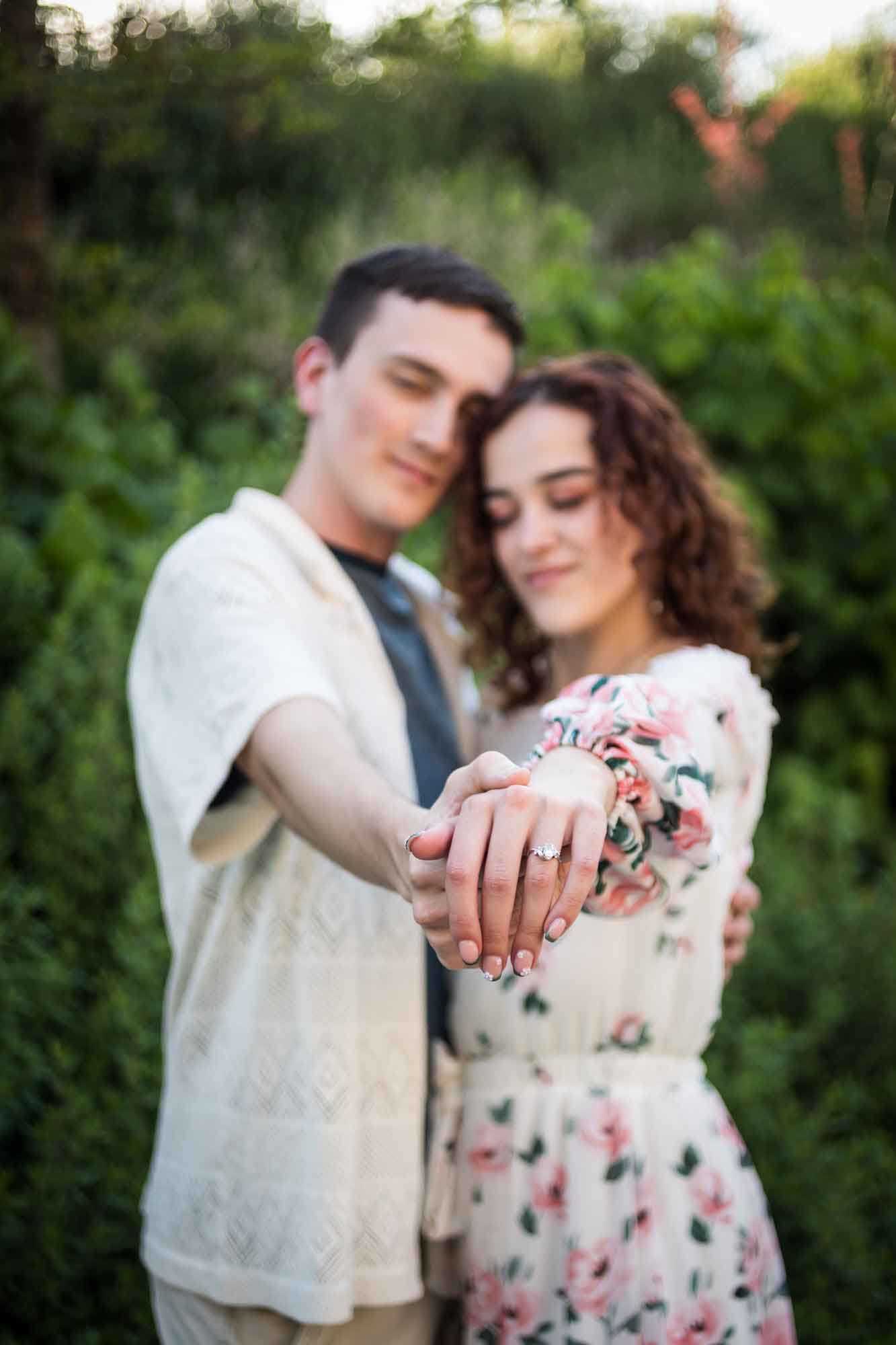Downtown San Antonio engagement photos of couple showing off engagement ring on woman's hand in San Pedro Creek Park