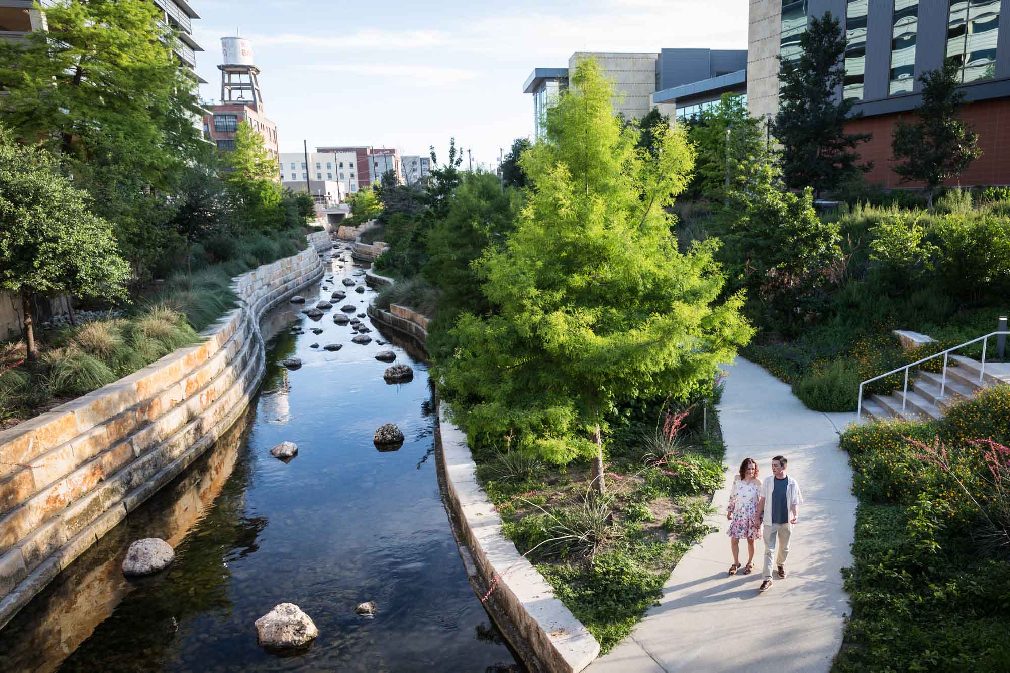 Couple walking along pathway with San Pedro Creek on other side