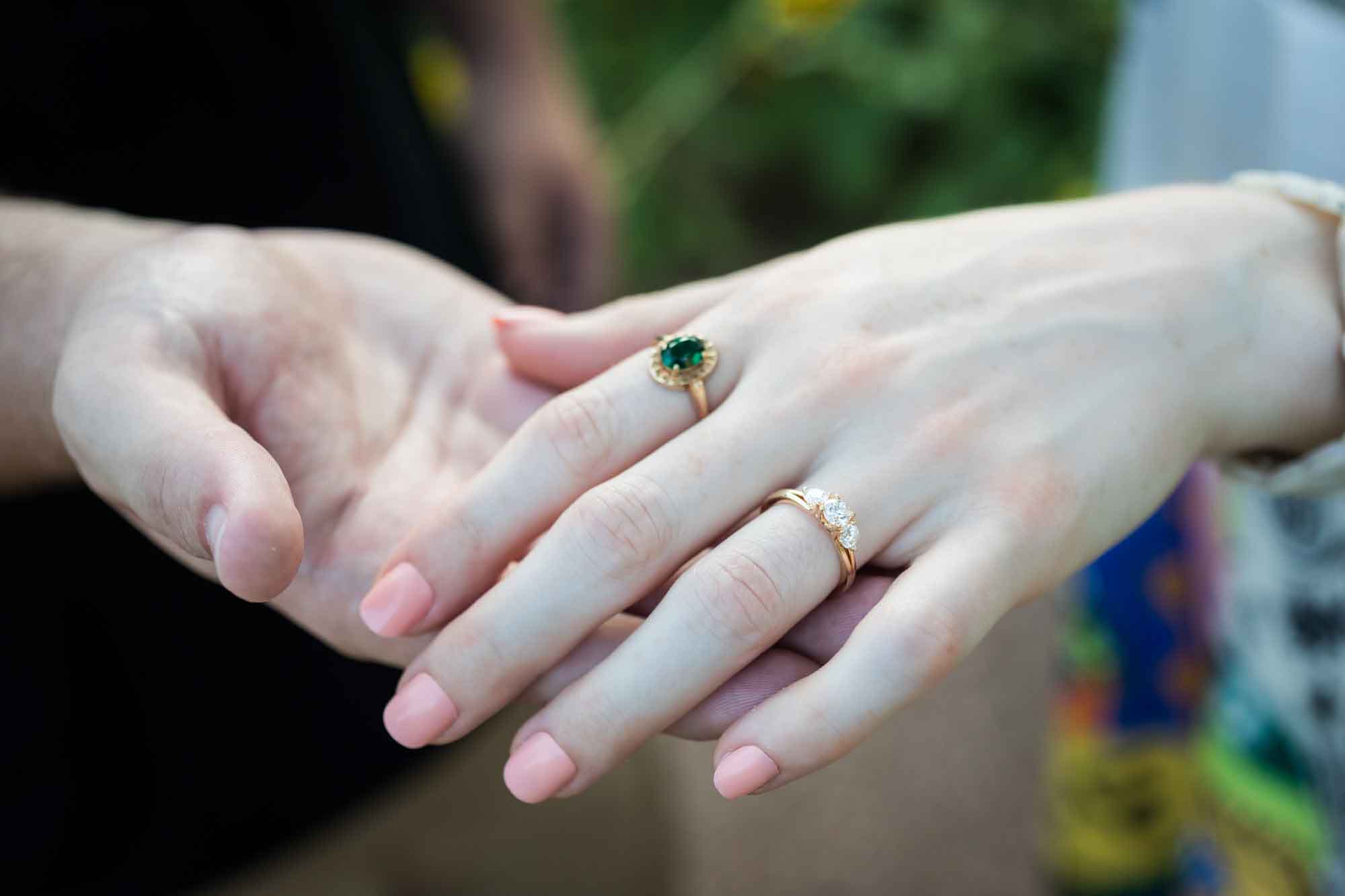 Close up of man holding woman's hand showing engagement ring