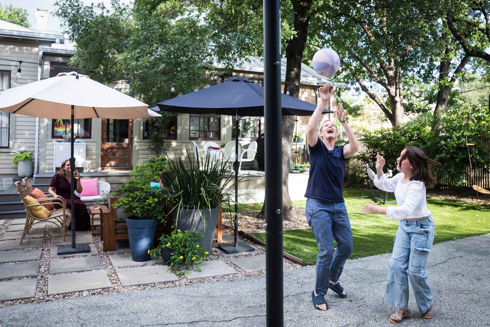Mother and teenage daughter playing basketball in backyard during a King William family portrait