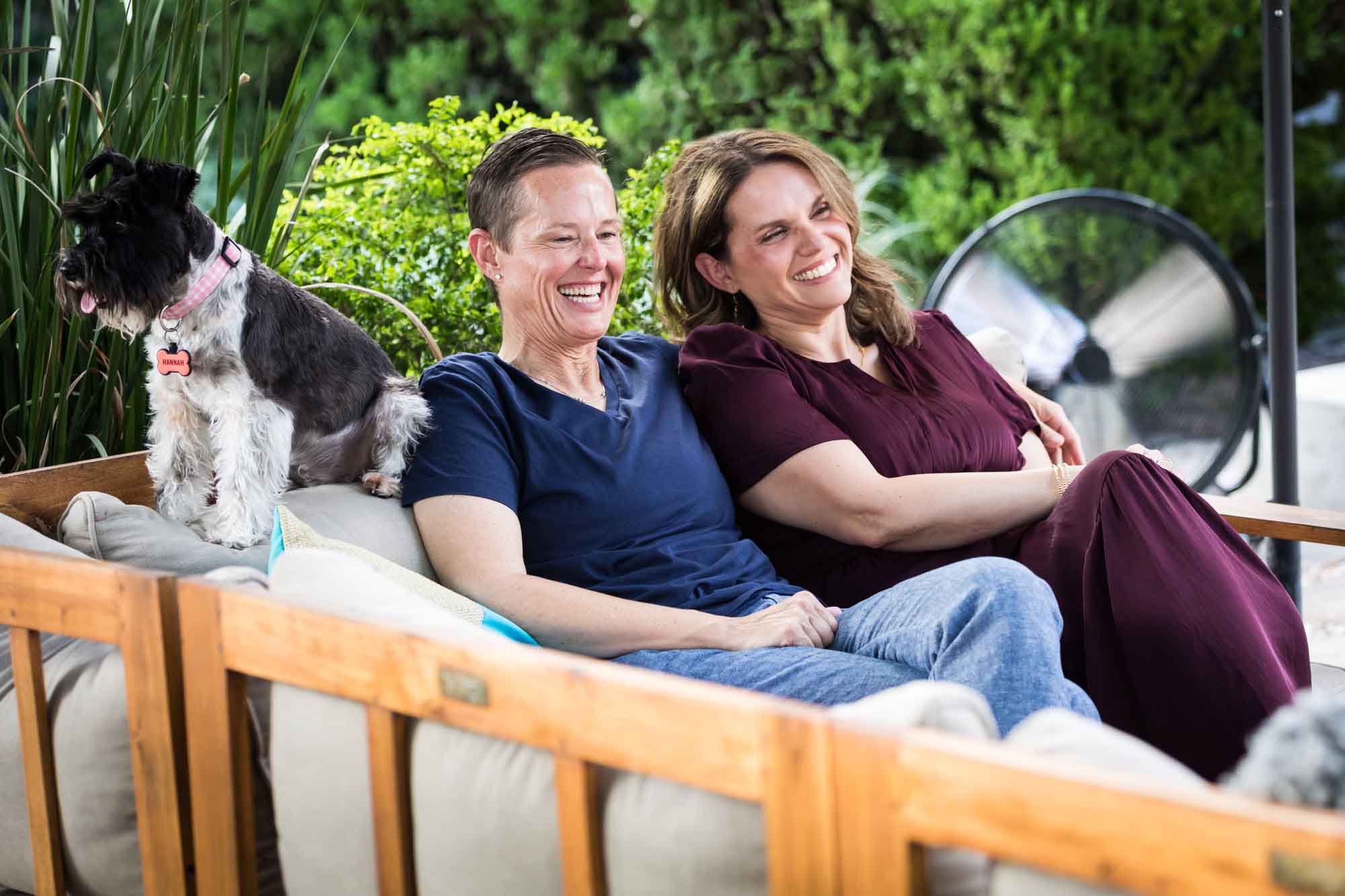 Two women seated on sofa with dog during a King William family portrait
