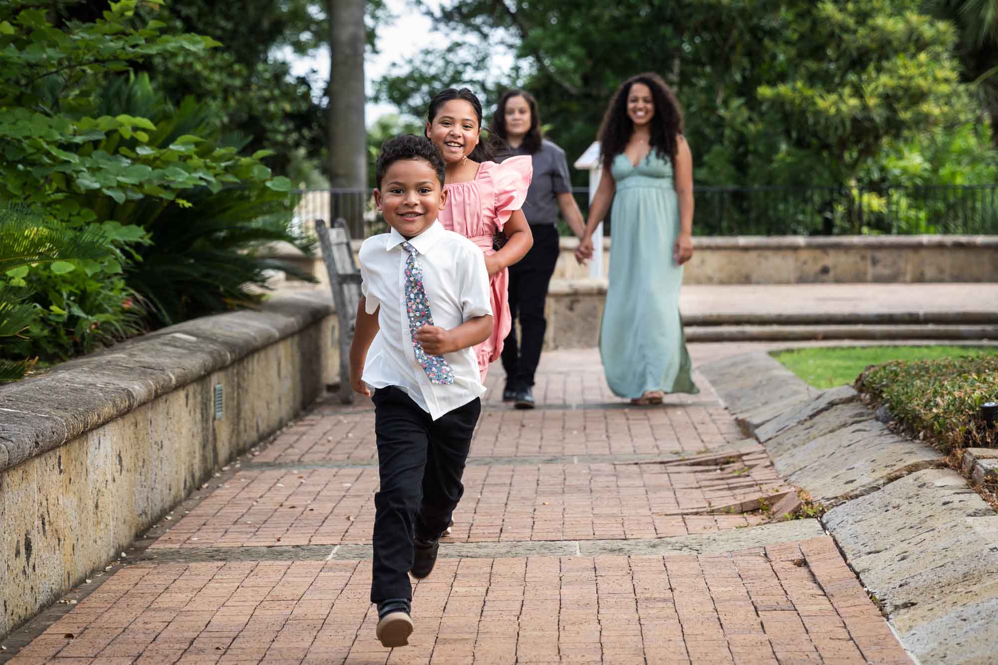 Little boy and girl running in front of two women for an article about McNay Art Museum proposal tips