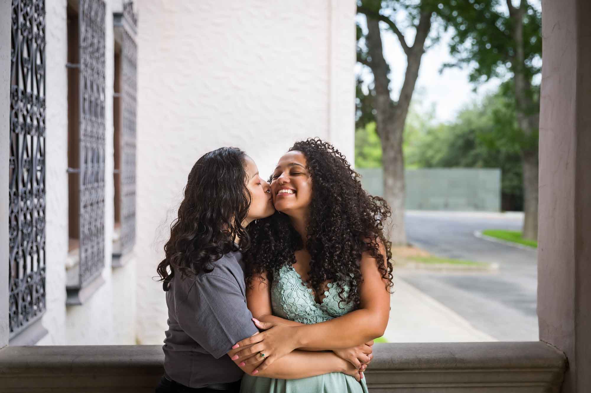 Two women kissing against railing for an article about McNay Art Museum proposal tips