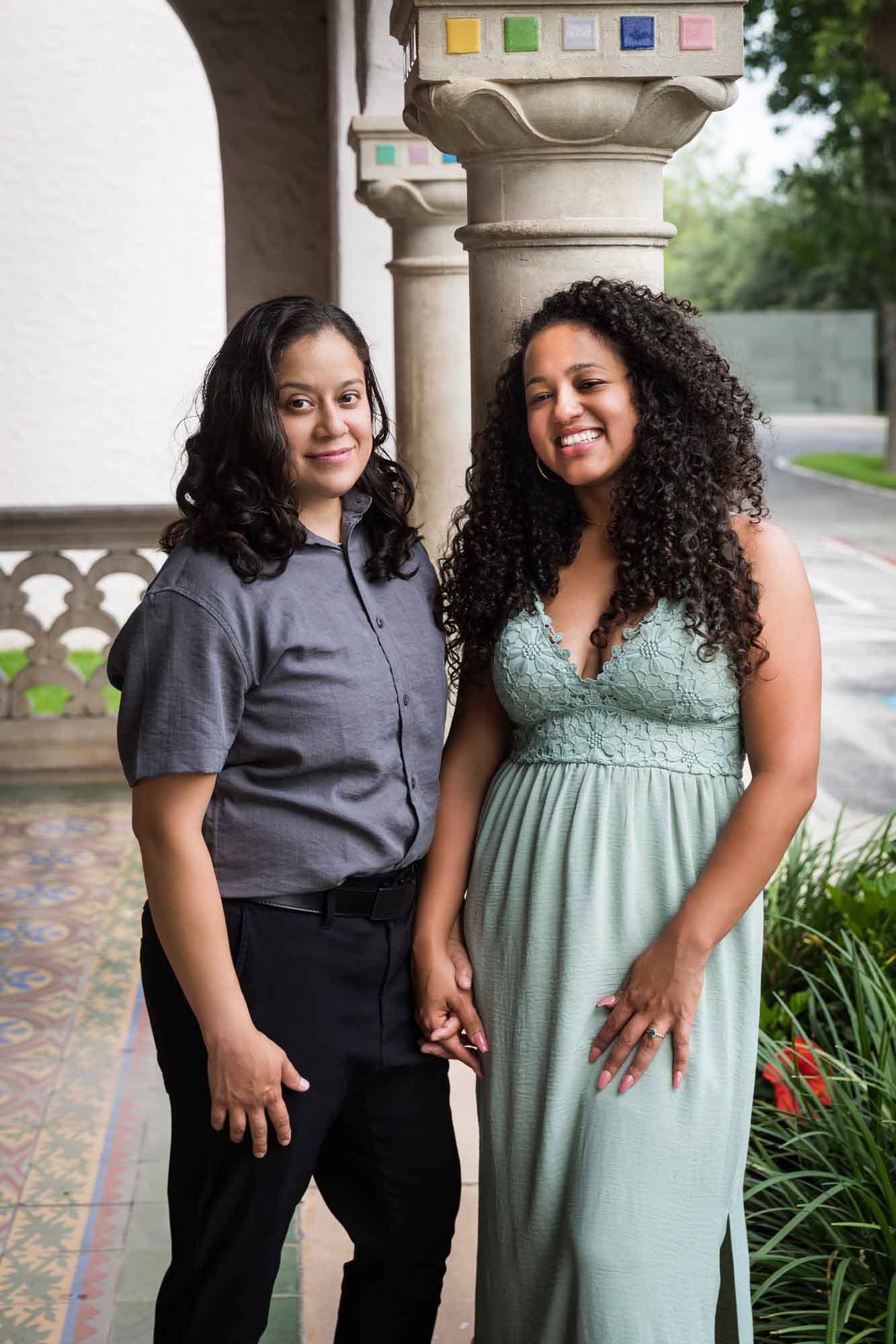 Two women hugging against multicolored mosaic column for an article about McNay Art Museum proposal tips