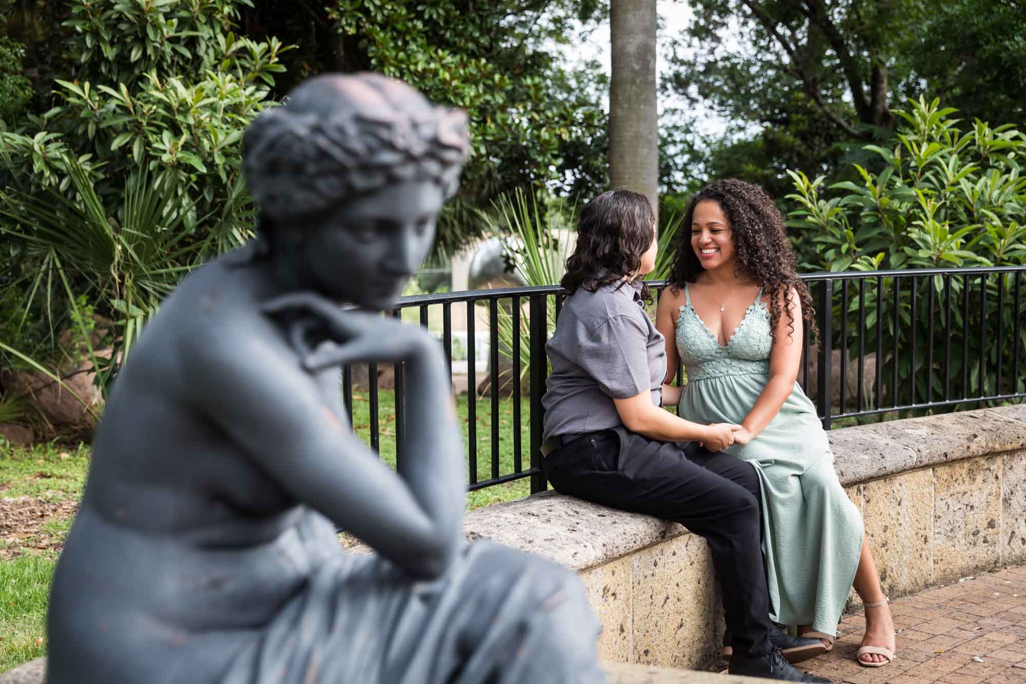 Bronze female sculpture with two women sitting in background for an article about McNay Art Museum proposal tips
