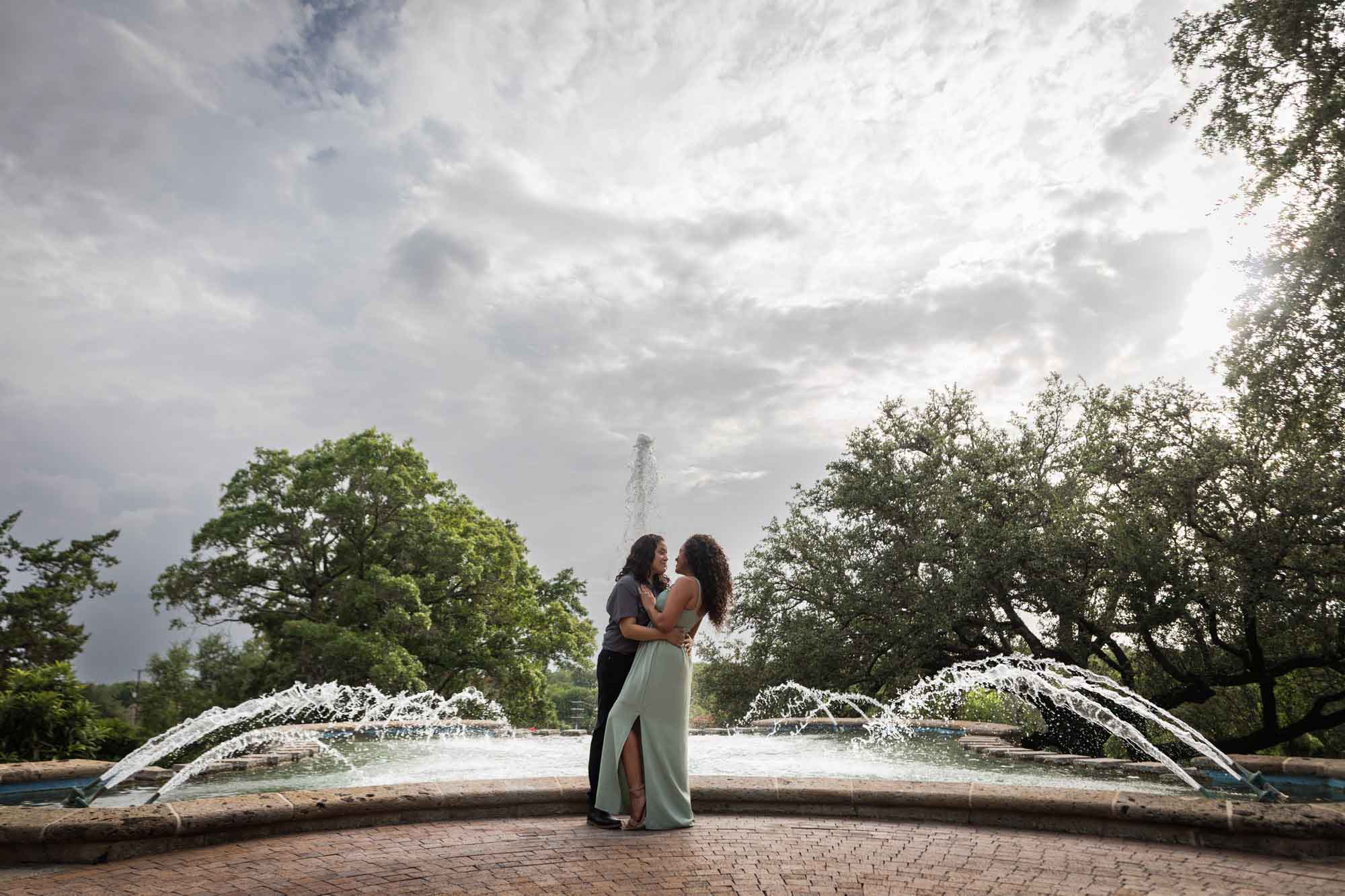 Two women hugging in front of McNay Art Museum fountain for an article about McNay Art Museum proposal tips