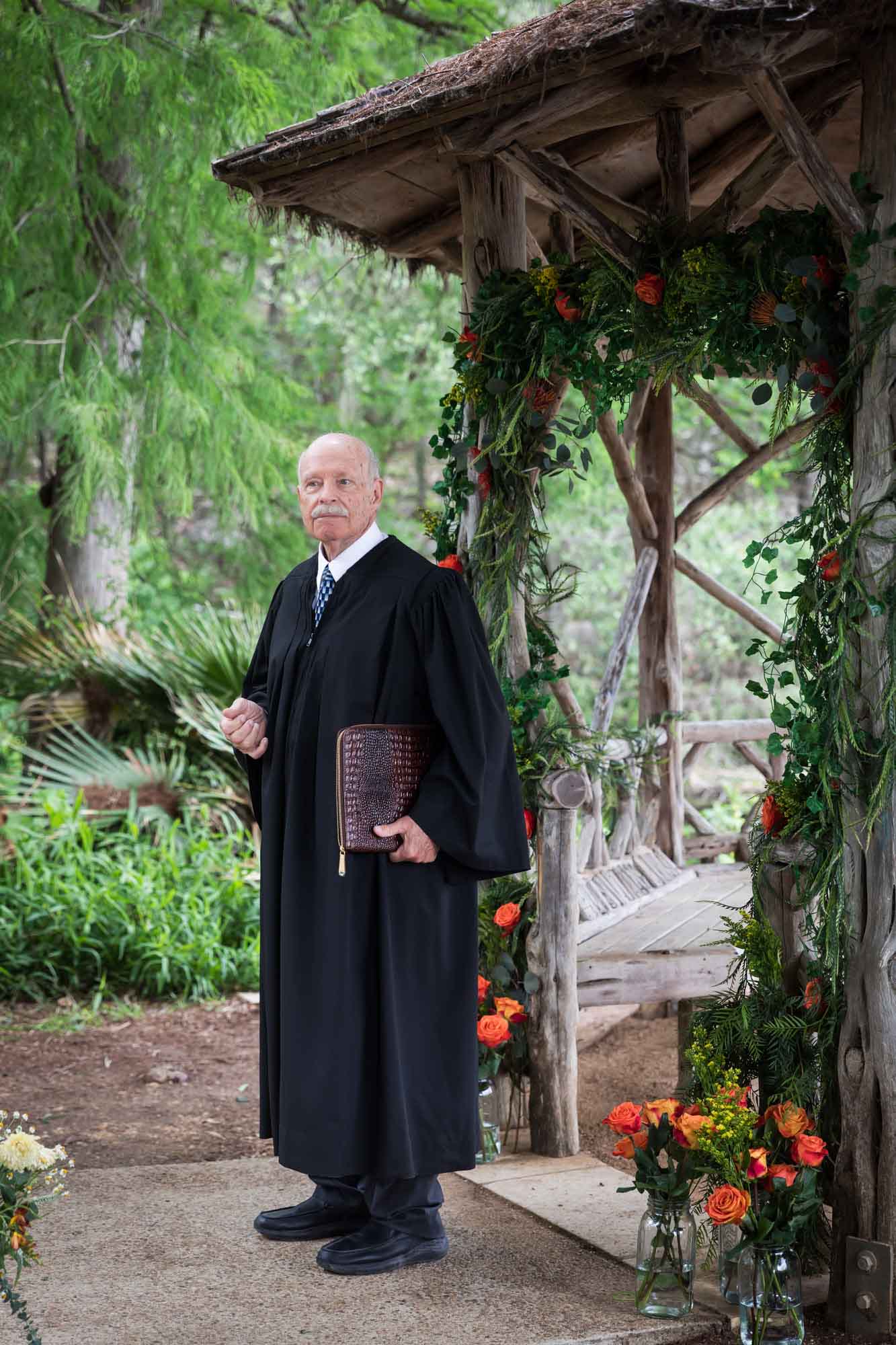 Officiant wearing black robe at Landa Park gazebo for an article on affordable wedding venues in San Antonio