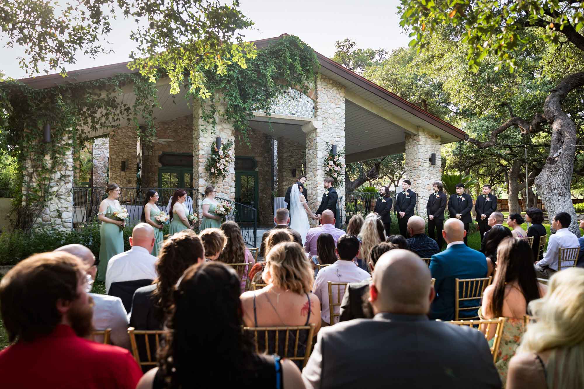Bride and groom during ceremony in front of guests at The Veranda for an article on affordable wedding venues in San Antonio