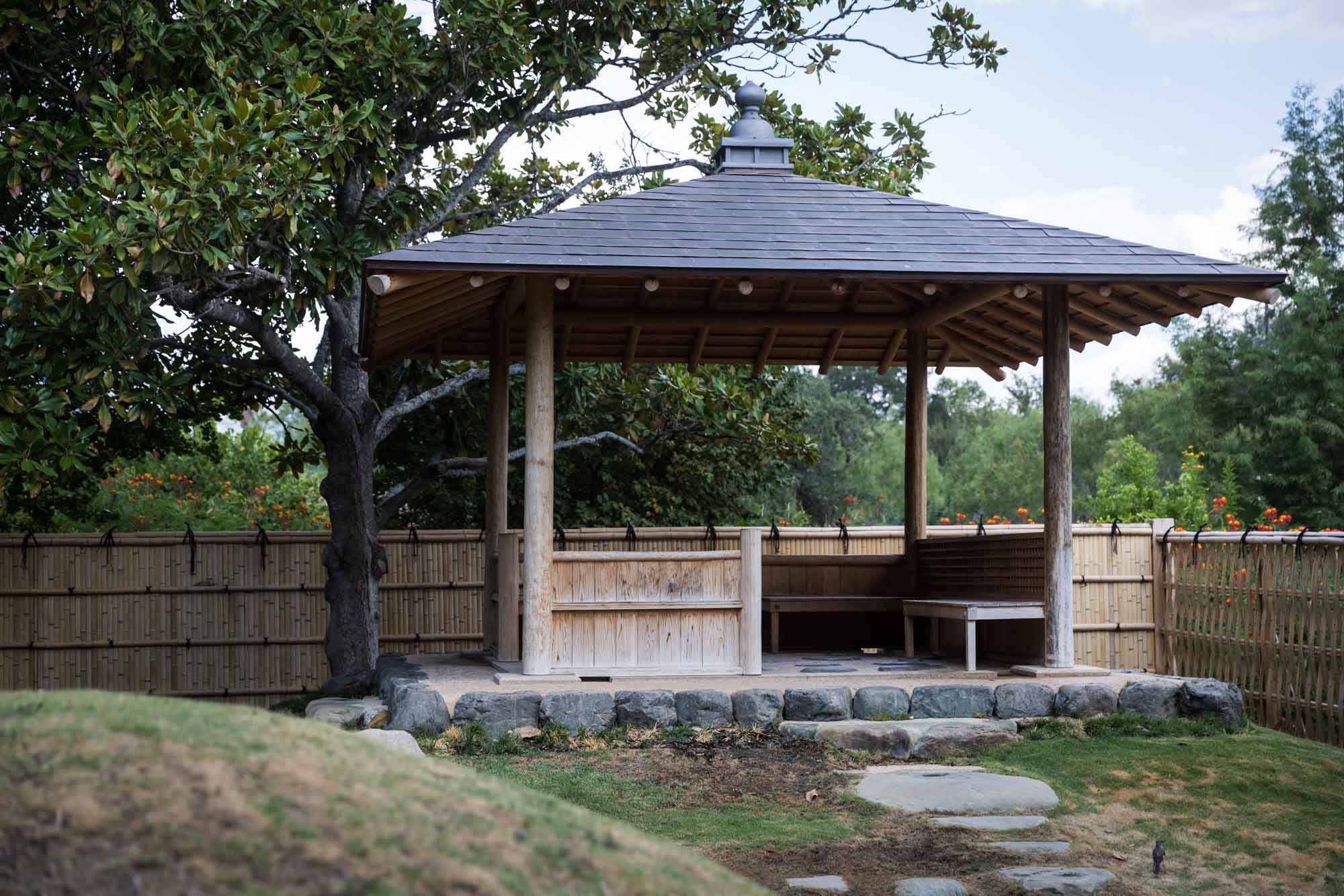 View of Kumamoto En Japanese Garden showing azumaya and bamboo fence for an article on the best San Antonio Botanical Garden photo locations
