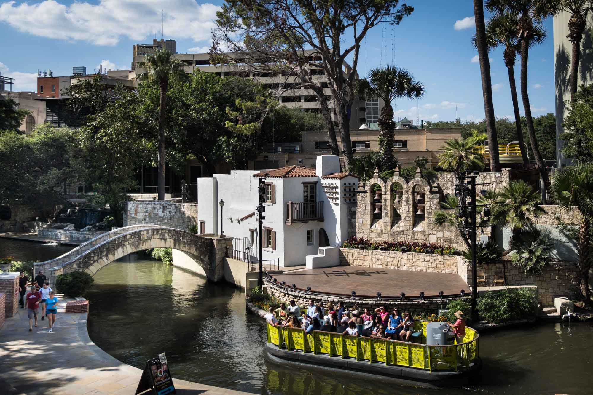 Yellow River Walk boat floating in front of the Arneson River Theatre in San Antonio