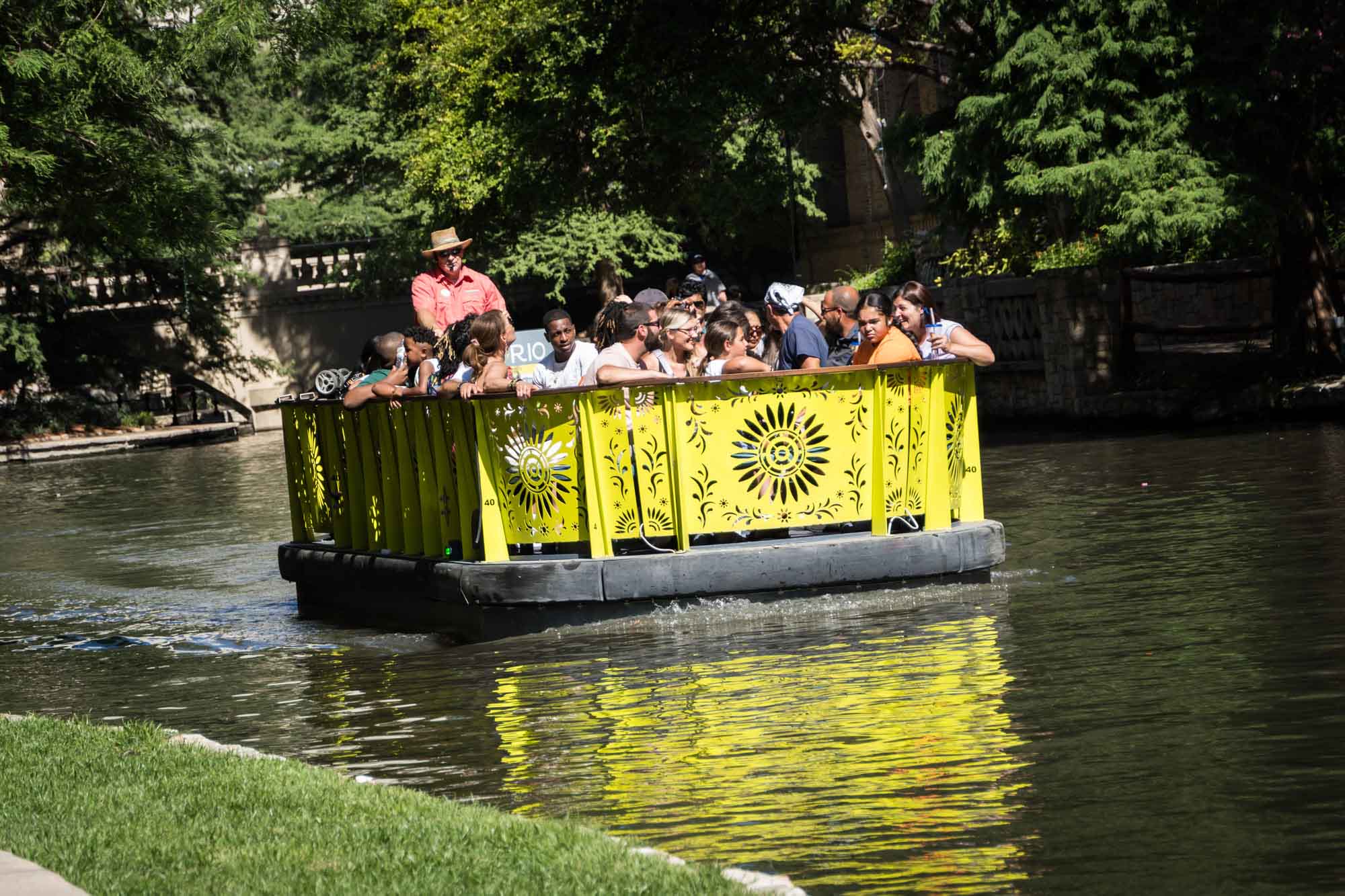 Yellow River Walk boat full of tourists floating down the San Antonio River