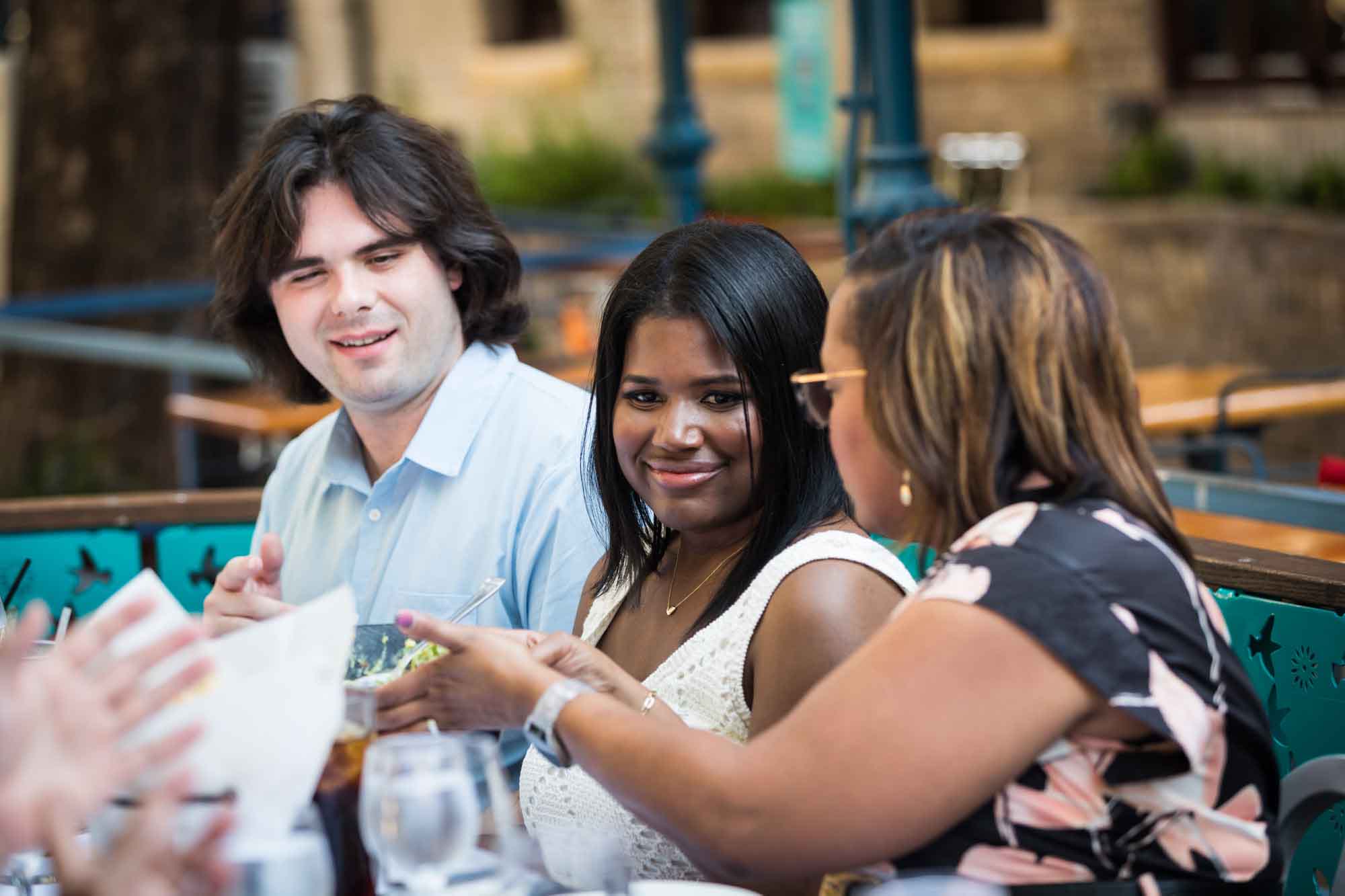 African American woman seated next to white man and African American woman for an article on how to get married on a River Walk boat