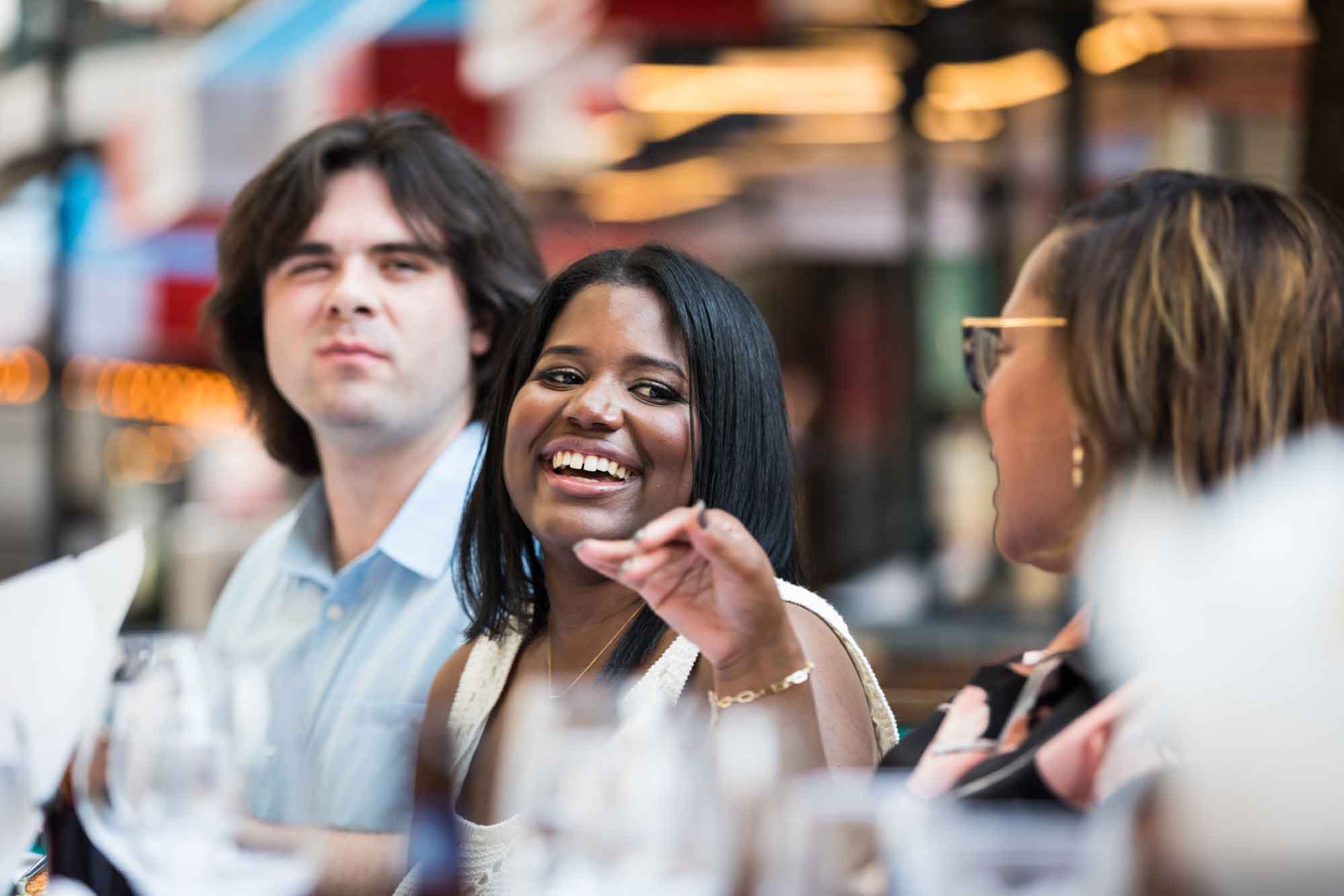 African American woman laughing surrounded by guests for an article on how to get married on a River Walk boat
