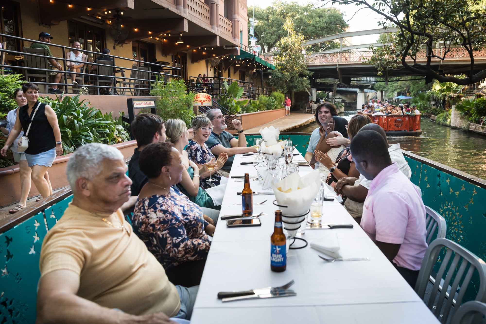 Table surrounded by guests enjoying themselves during dinner cruise flowing on River Walk for an article on how to get married on a River Walk boat