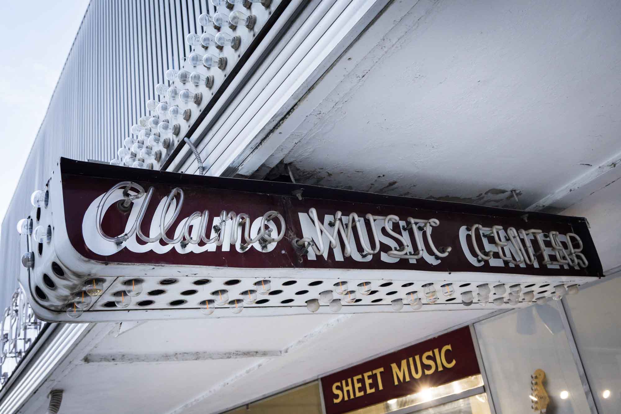 Retro neon storefront of Alamo Music Center in downtown San Antonio