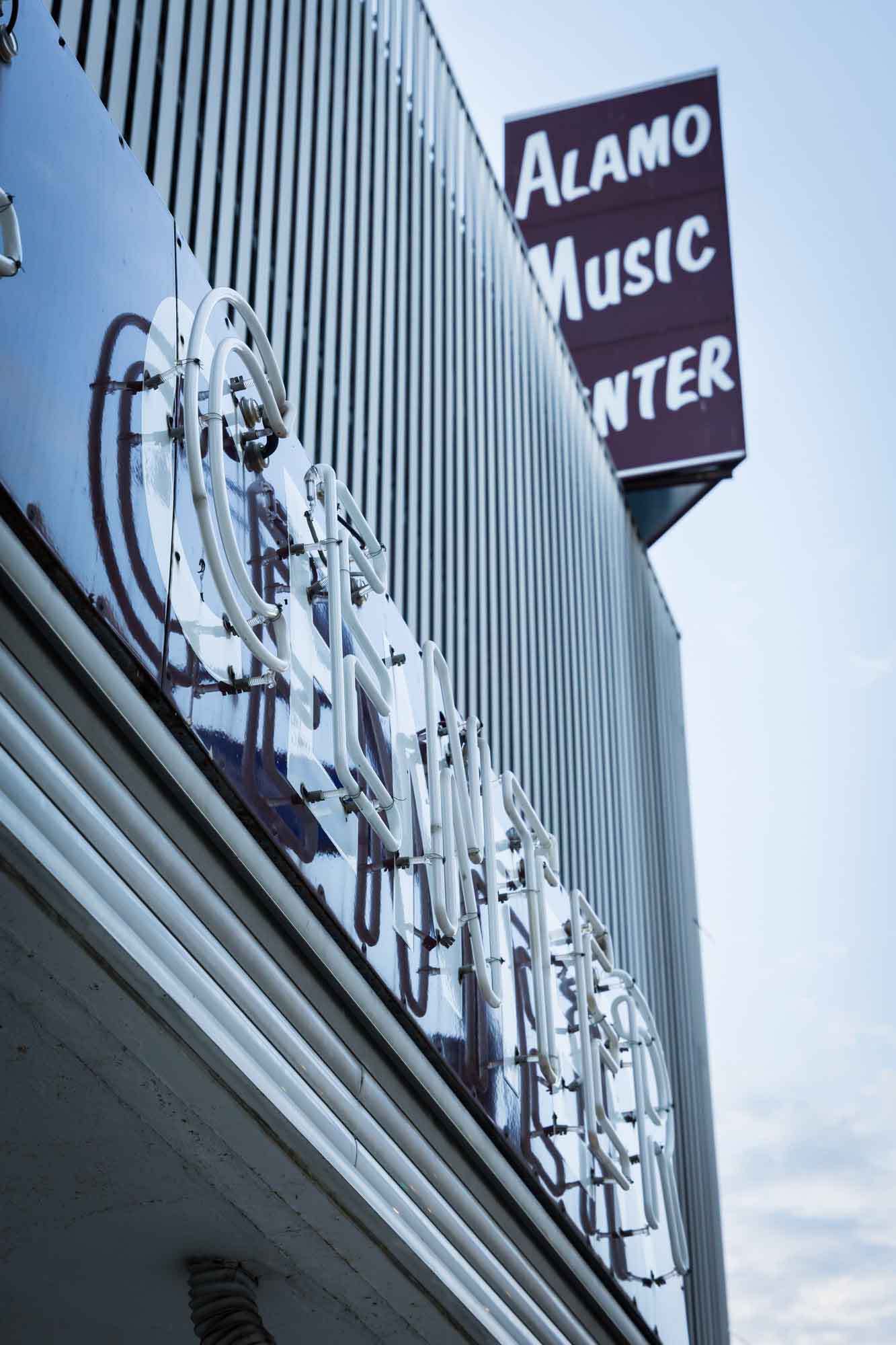 Retro neon storefront of Alamo Music Center in downtown San Antonio