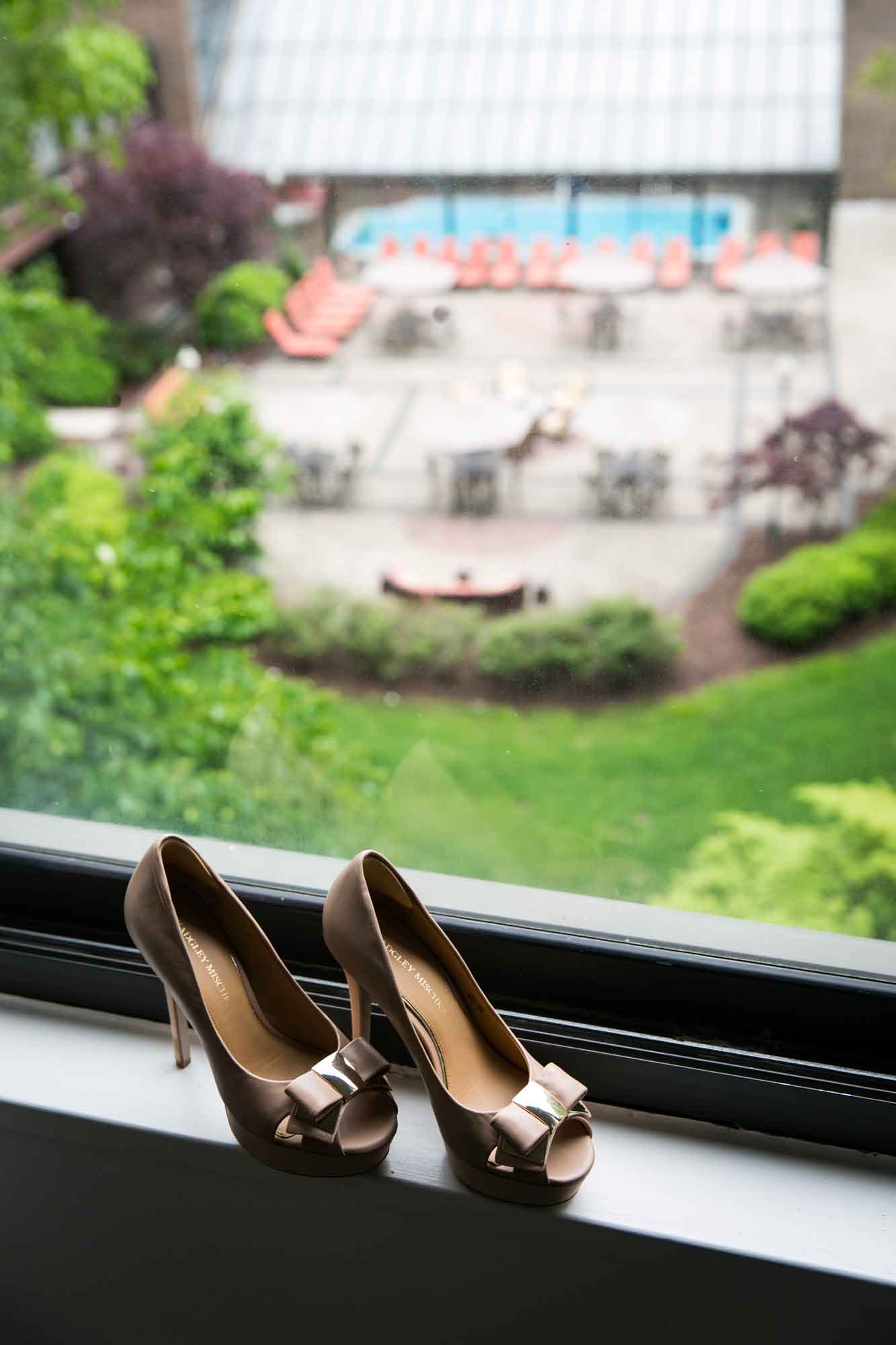 A bride's heels in a window for an article on what to have ready when the wedding photographer arrives