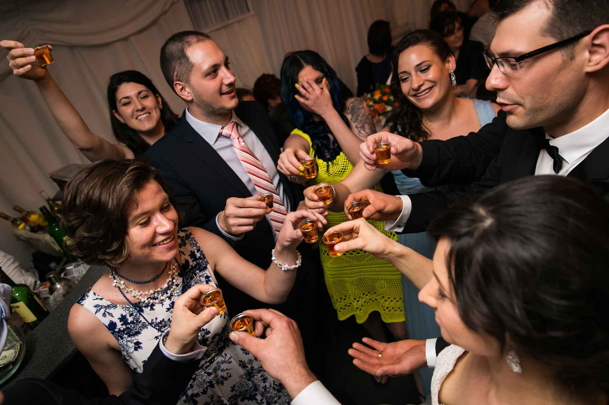 Guests toasting at a Pelham Bay & Split Rock Golf Club wedding reception for an article on what to have ready when the wedding photographer arrives