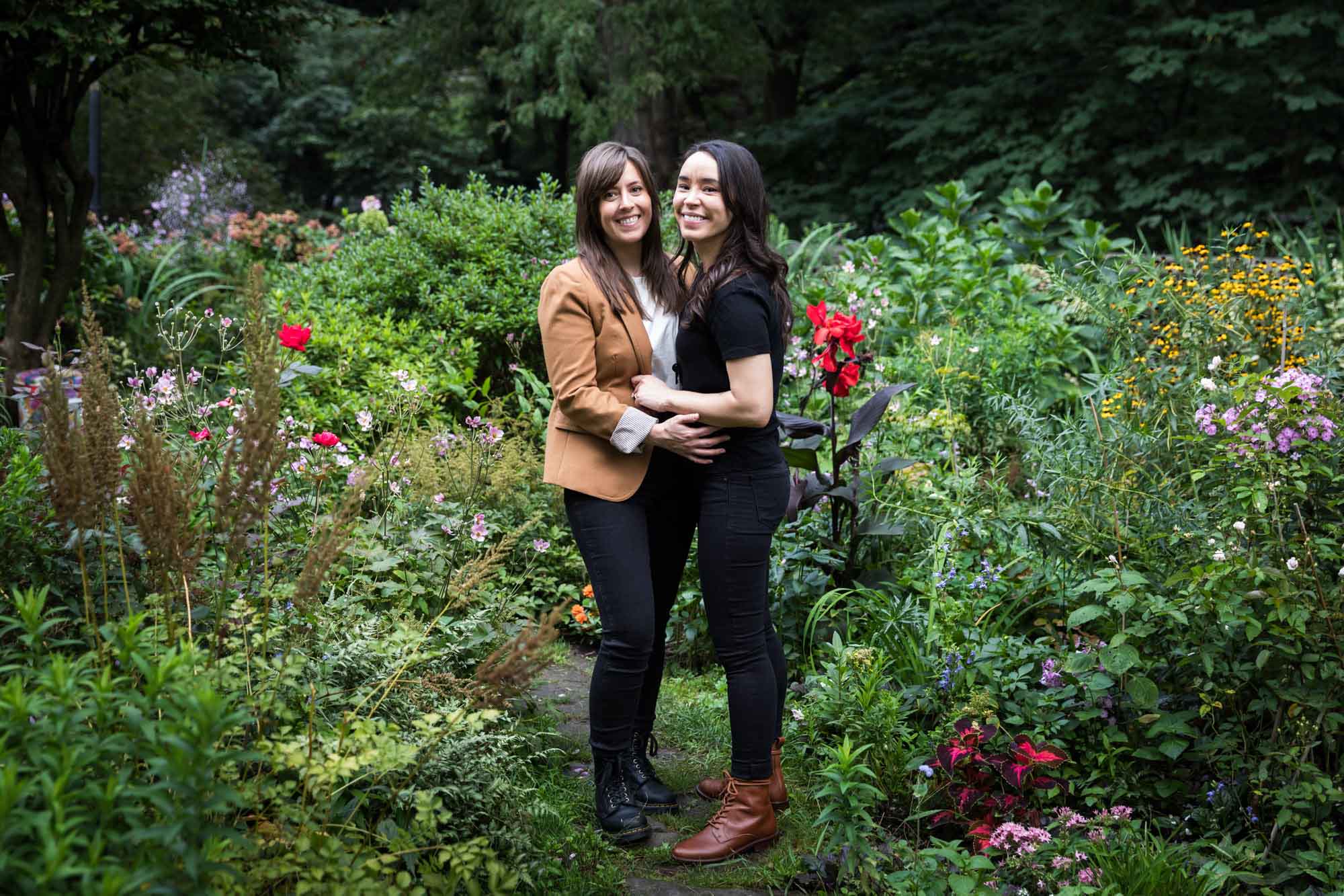 Lesbian couple hugging in middle of colorful garden for article on best Ziliker Botanical Garden photo locations