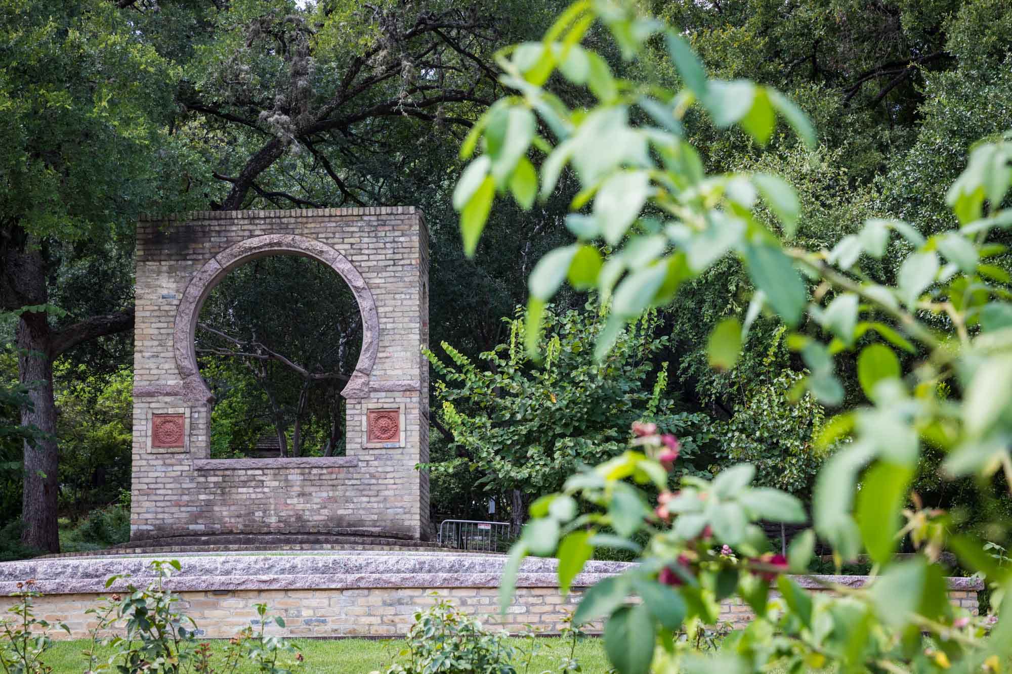 Butler Window with green bushes on the side in rose garden for an article on the best Zilker Botanical Garden photo locations