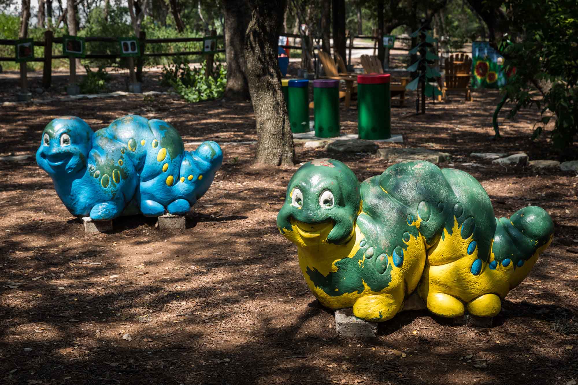 Colorful caterpillar sculptures in a playground for an article on the best Zilker Botanical Garden photo locations