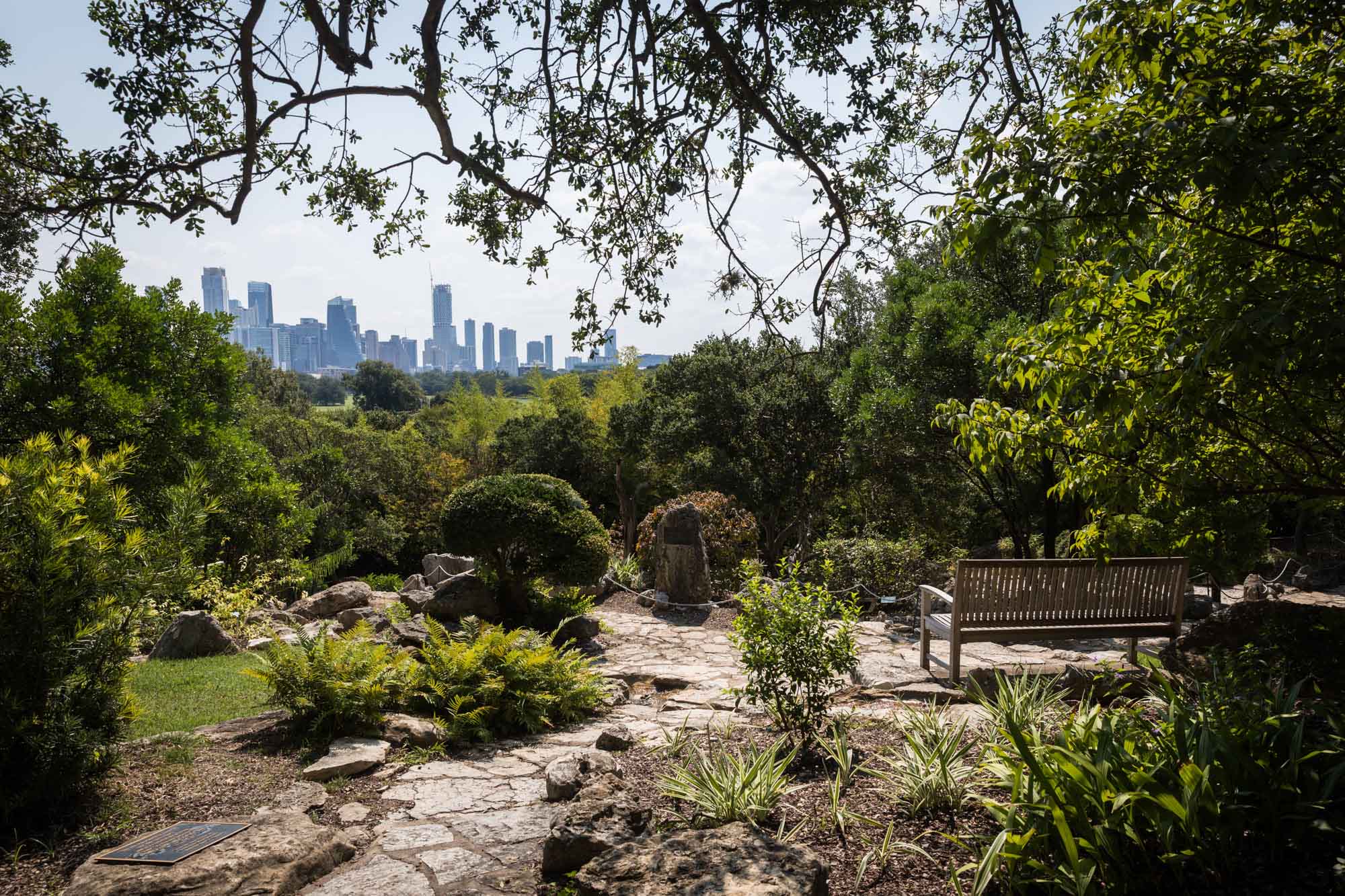 View of downtown Austin from Taniguchi Japanese Garden for an article on the best Zilker Botanical Garden photo locations