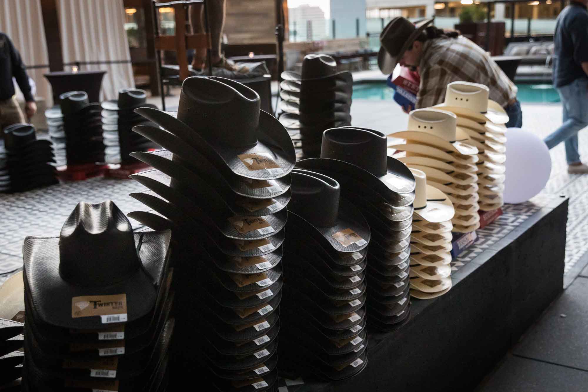 Stage full of black and white cowboy hats during a Hotel Van Zandt corporate event