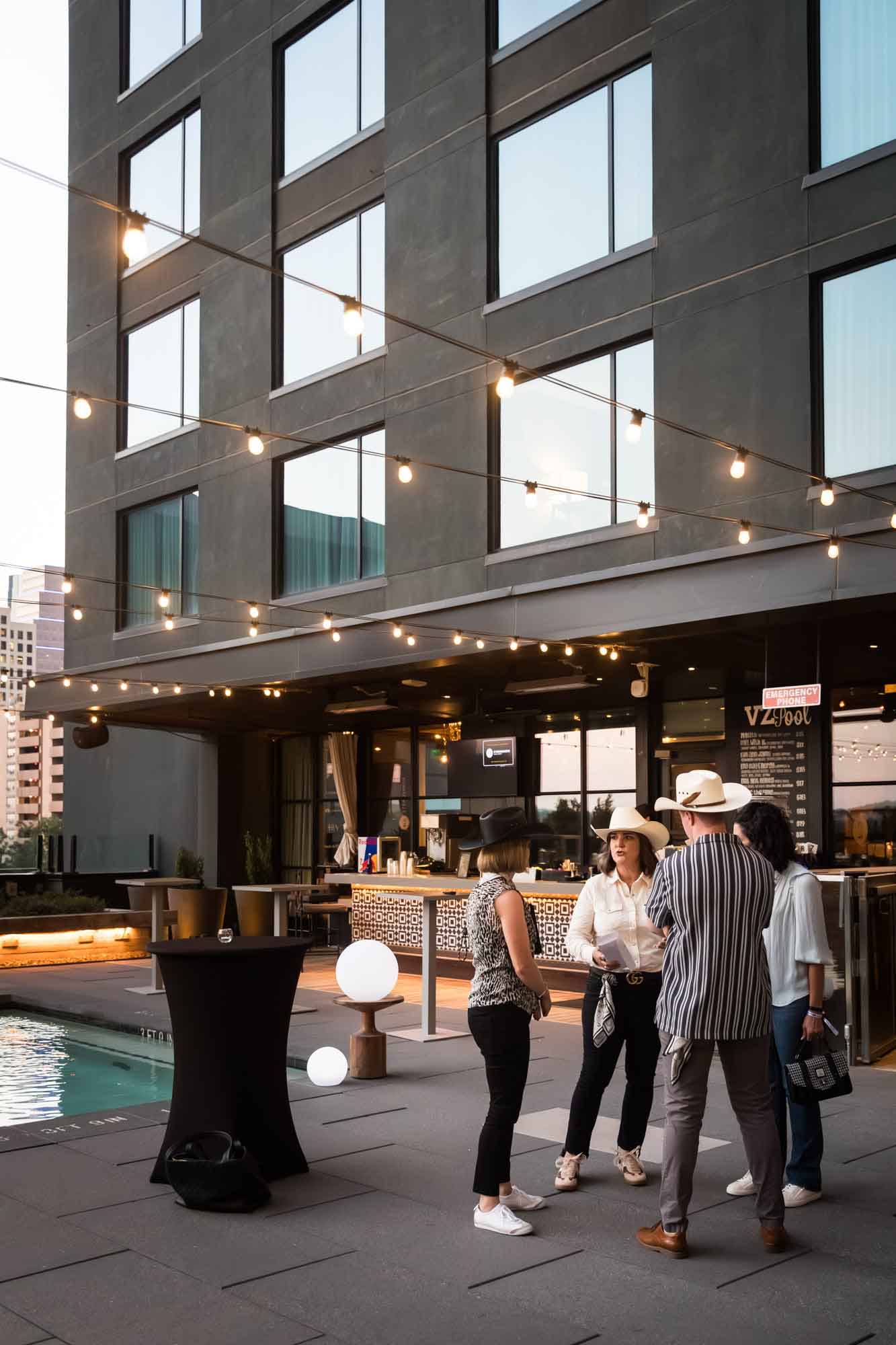Guests talking on pool deck during a Hotel Van Zandt corporate event
